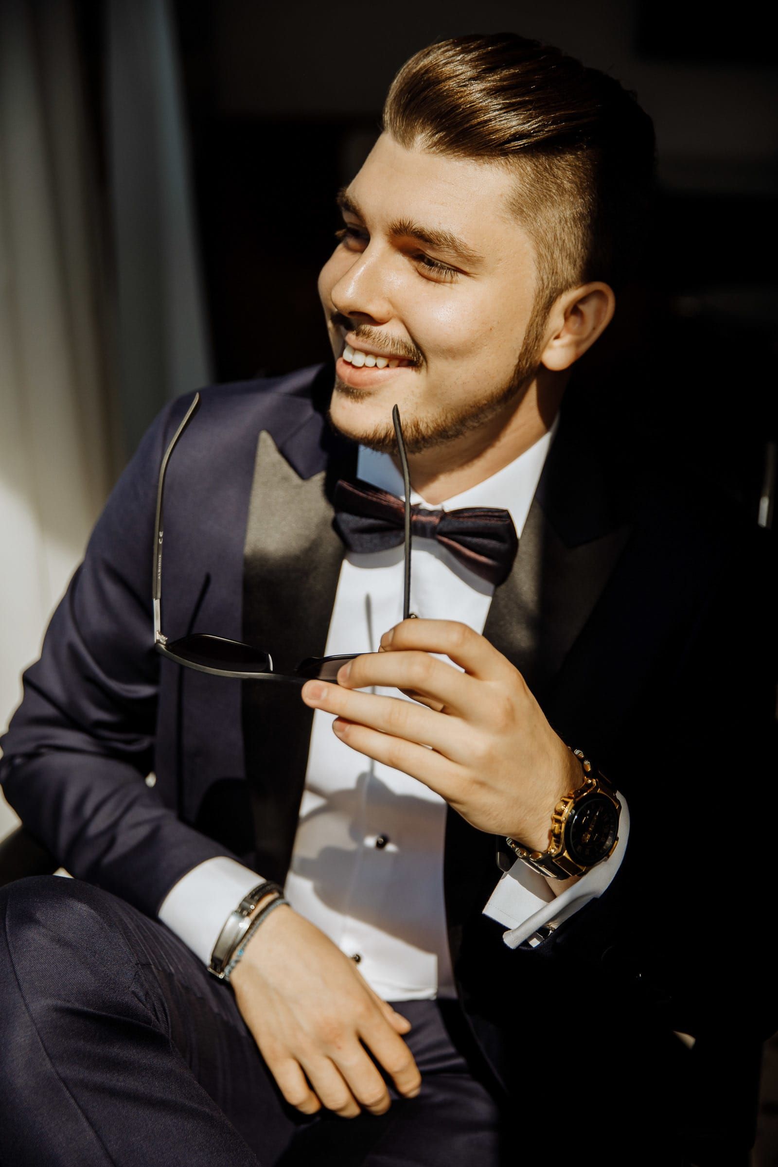 A GQ-style editorial portrait of a groom in a sharp tuxedo, by a Cornwall wedding photographer, Tanya Bogdan.