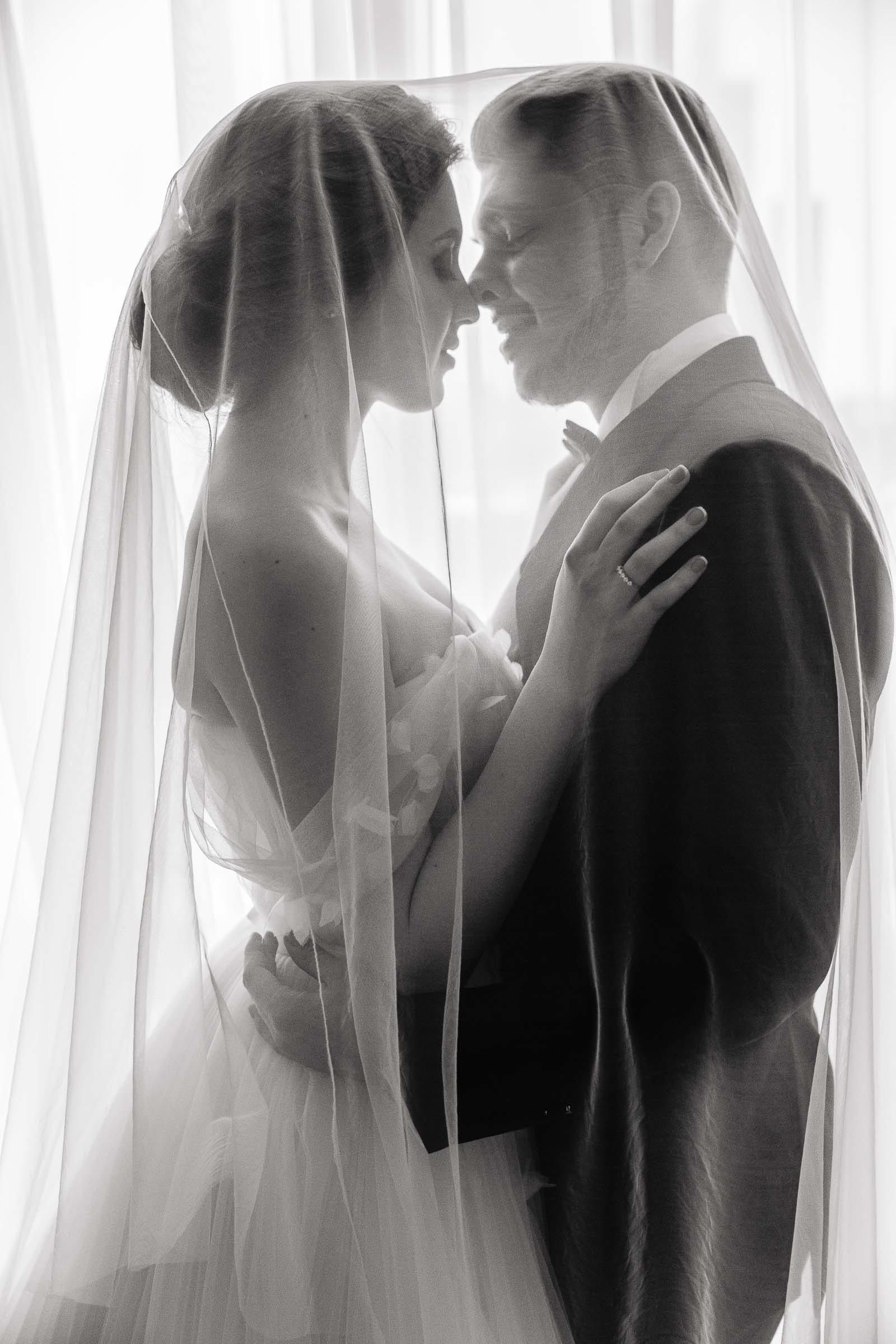 A timeless black-and-white editorial portrait of a bride and groom.