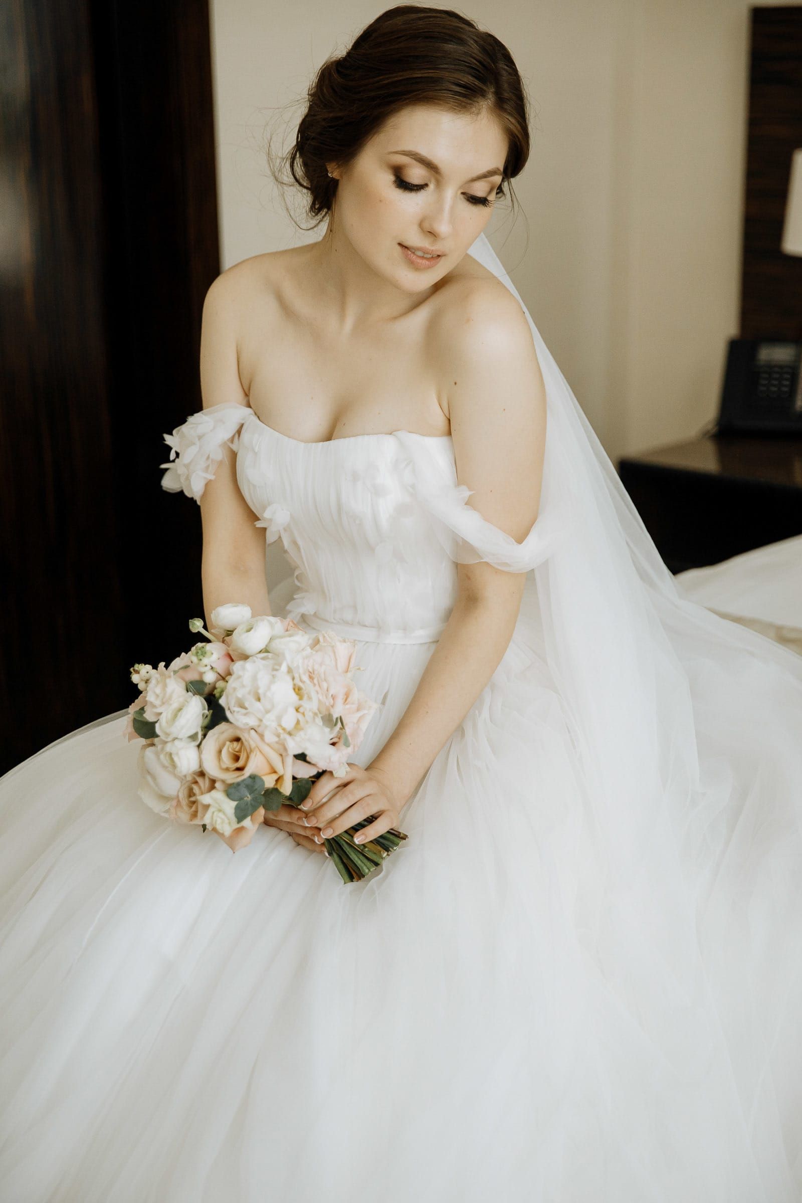 Modern bridal portrait of the bride holding her bouquet, by a Bude wedding photographer, Tanya Bogdan.