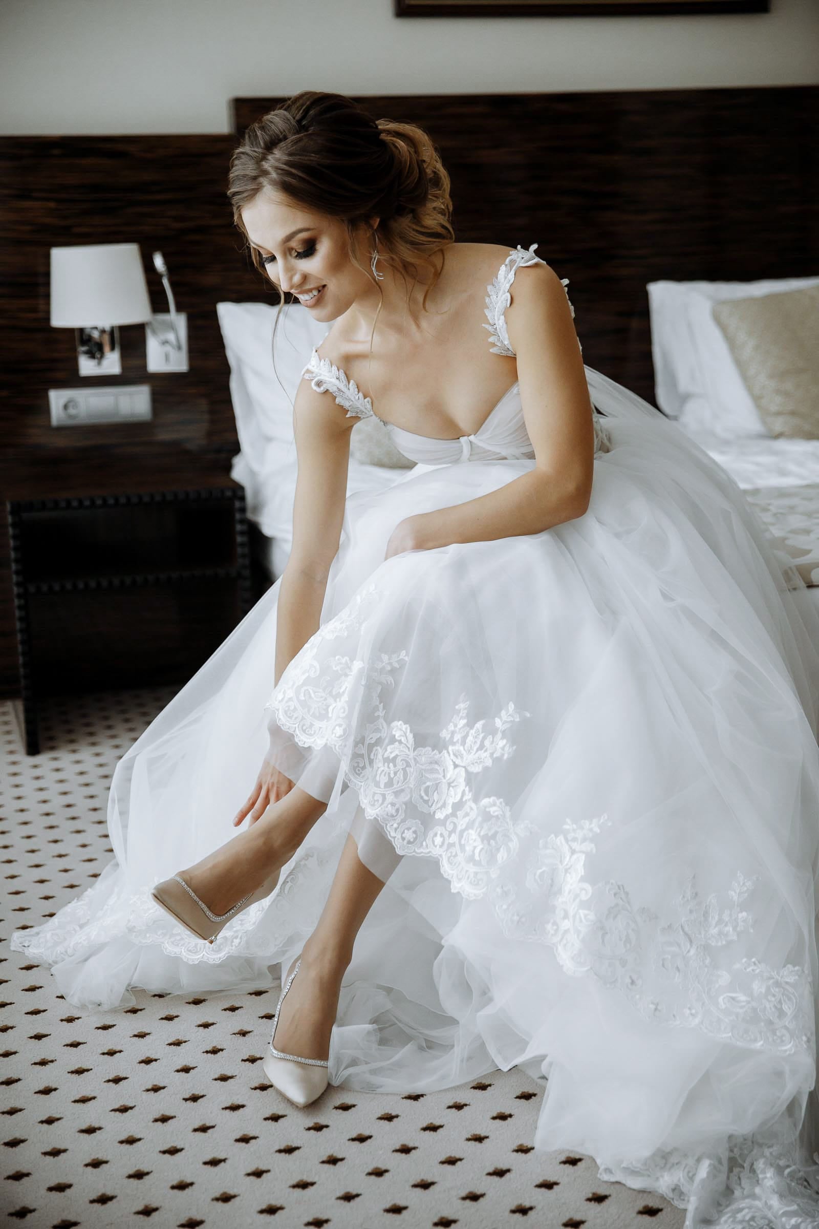 Stunning bride portrait style, putting on shoes. Tanya Bogdan editorial wedding photography.