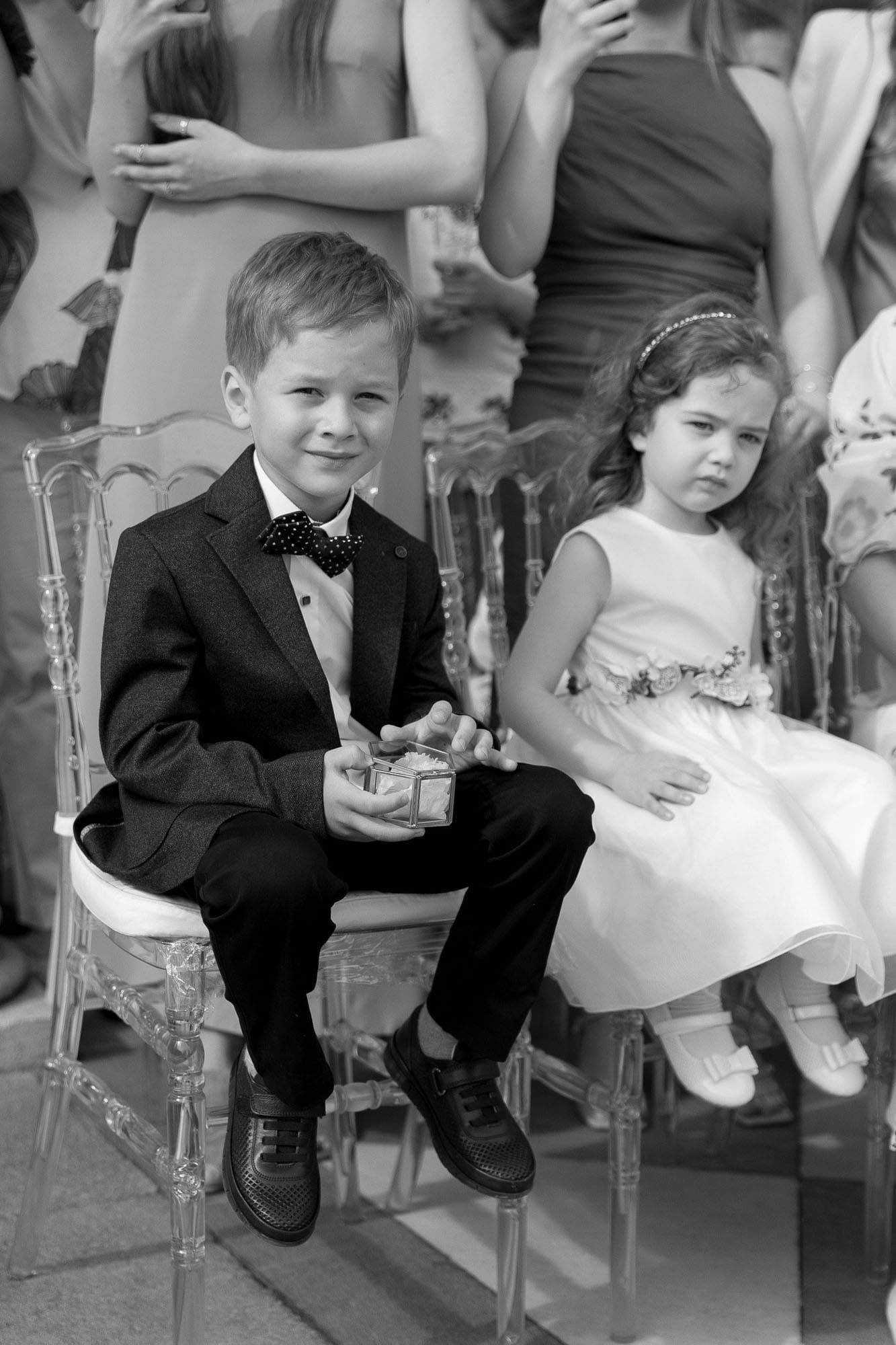 Flower girl and page boy watching the ceremony together during the vows at a destination wedding ceremony
