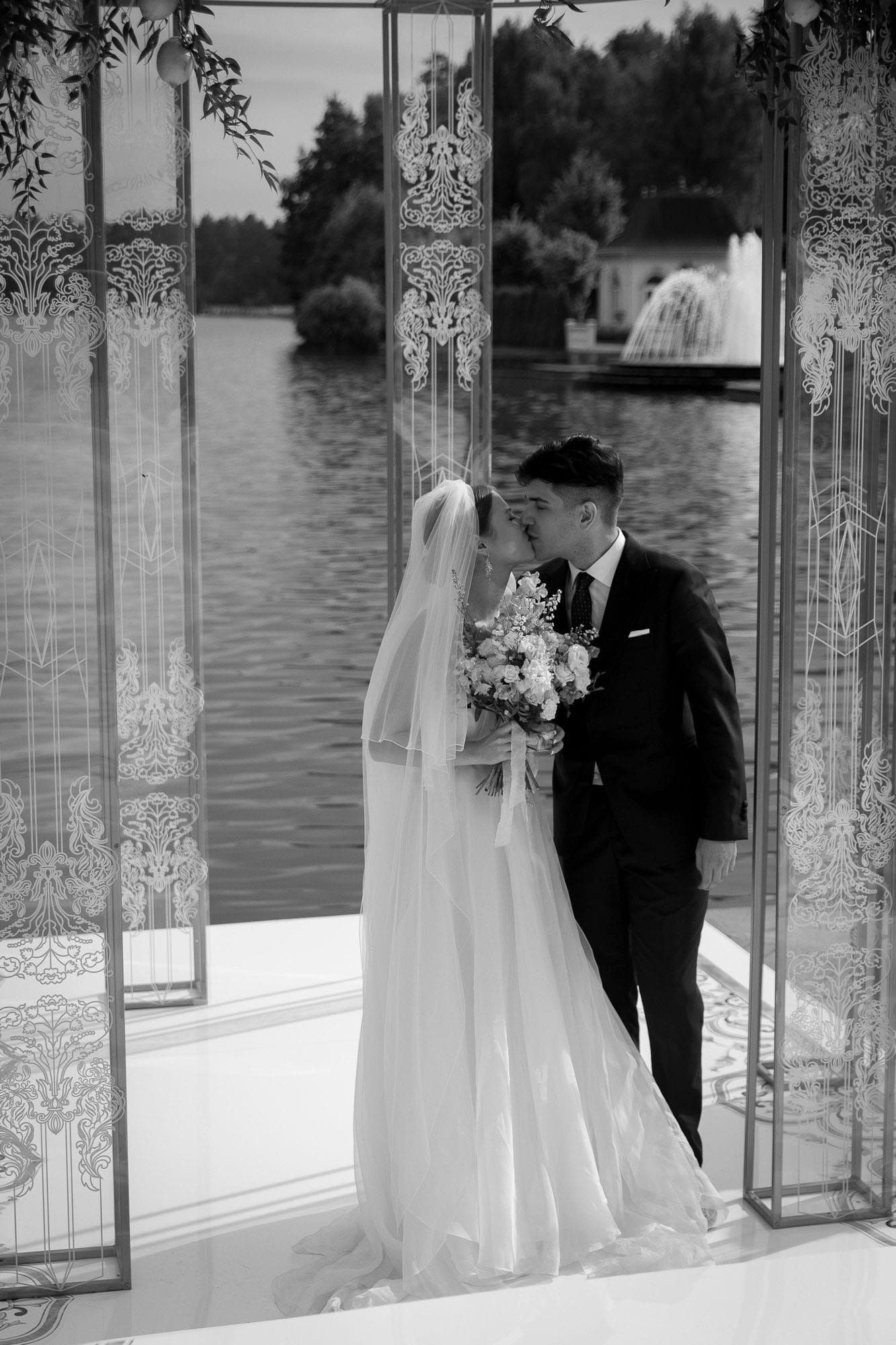 Bride and groom sharing their first kiss during the destination wedding ceremony