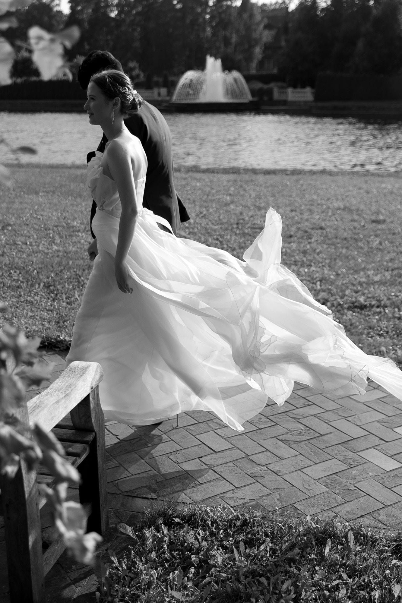 Bride and groom walking together in a garden after their destination wedding ceremony
