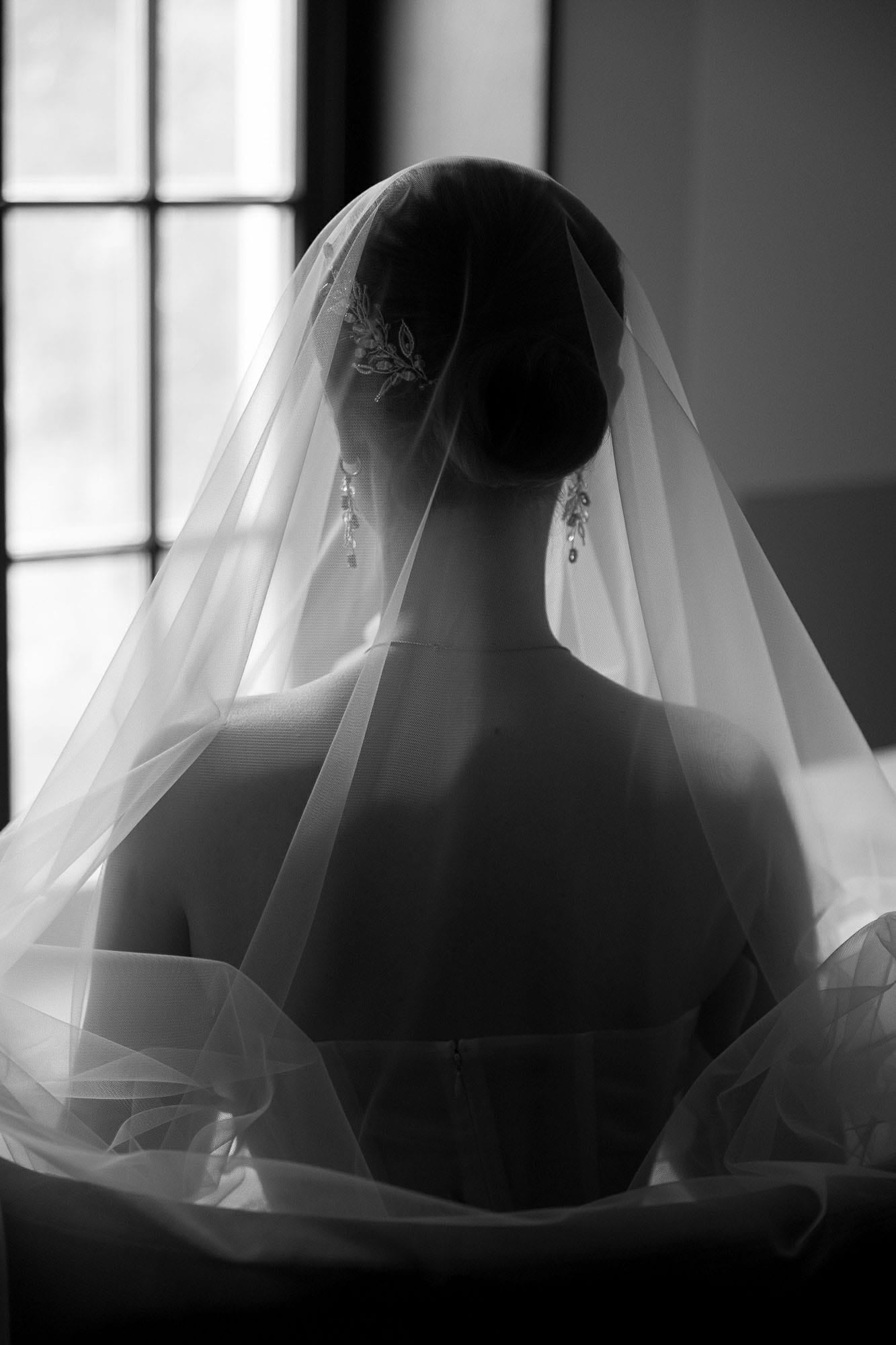 Black and white portrait of the bride from behind during destination wedding preparations