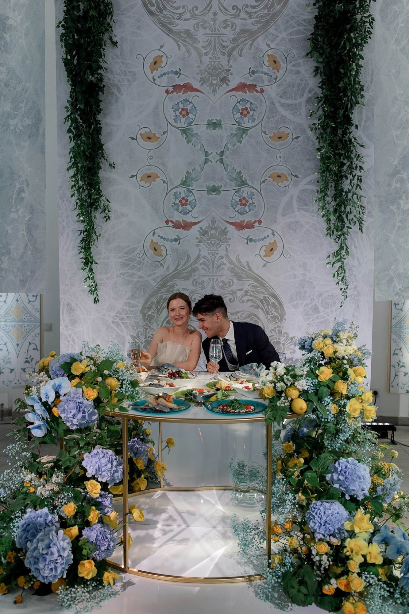 Bride and groom seated together at the top table during their destination wedding reception