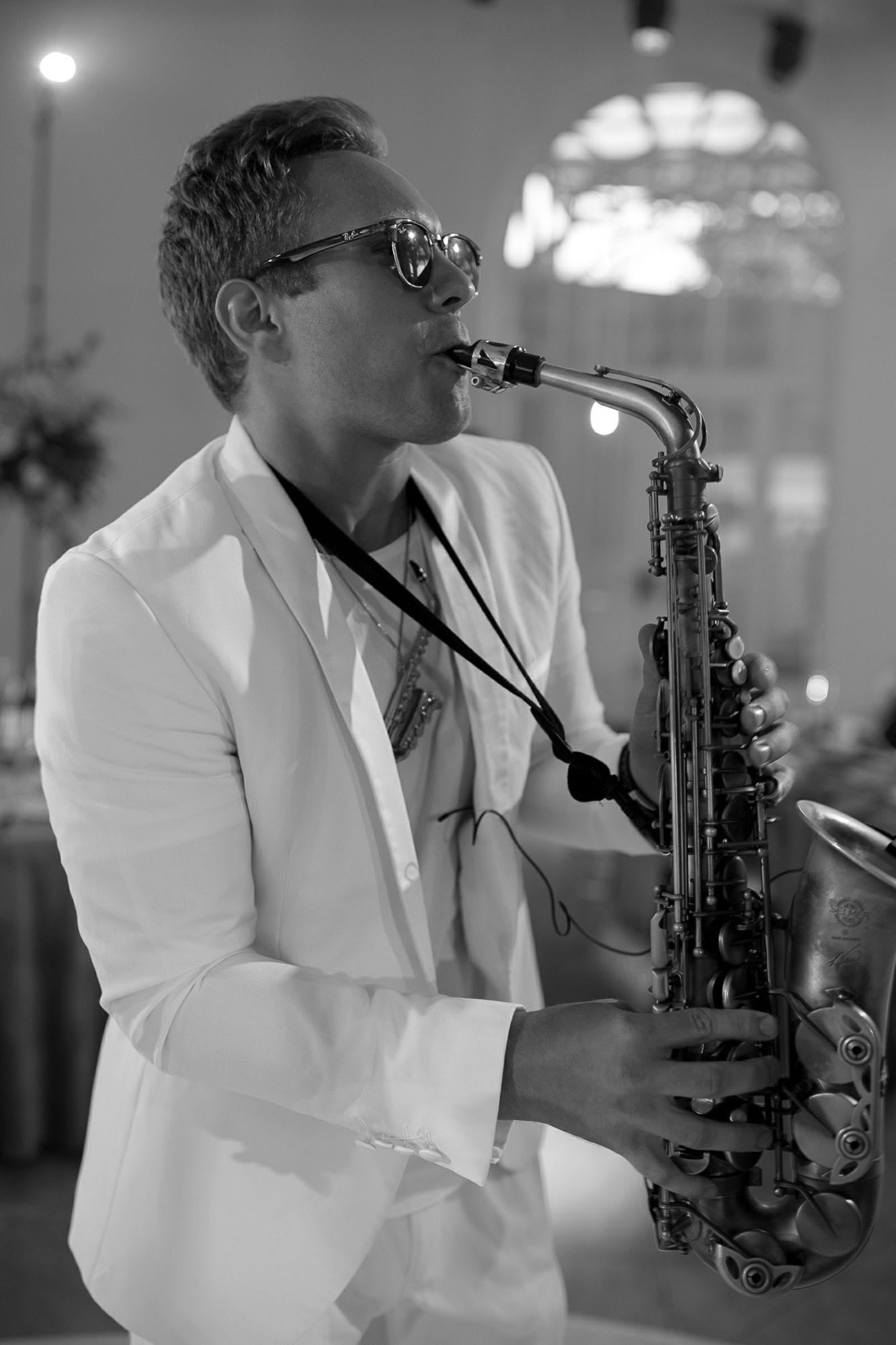 Saxophone player entertaining guests during a destination wedding reception