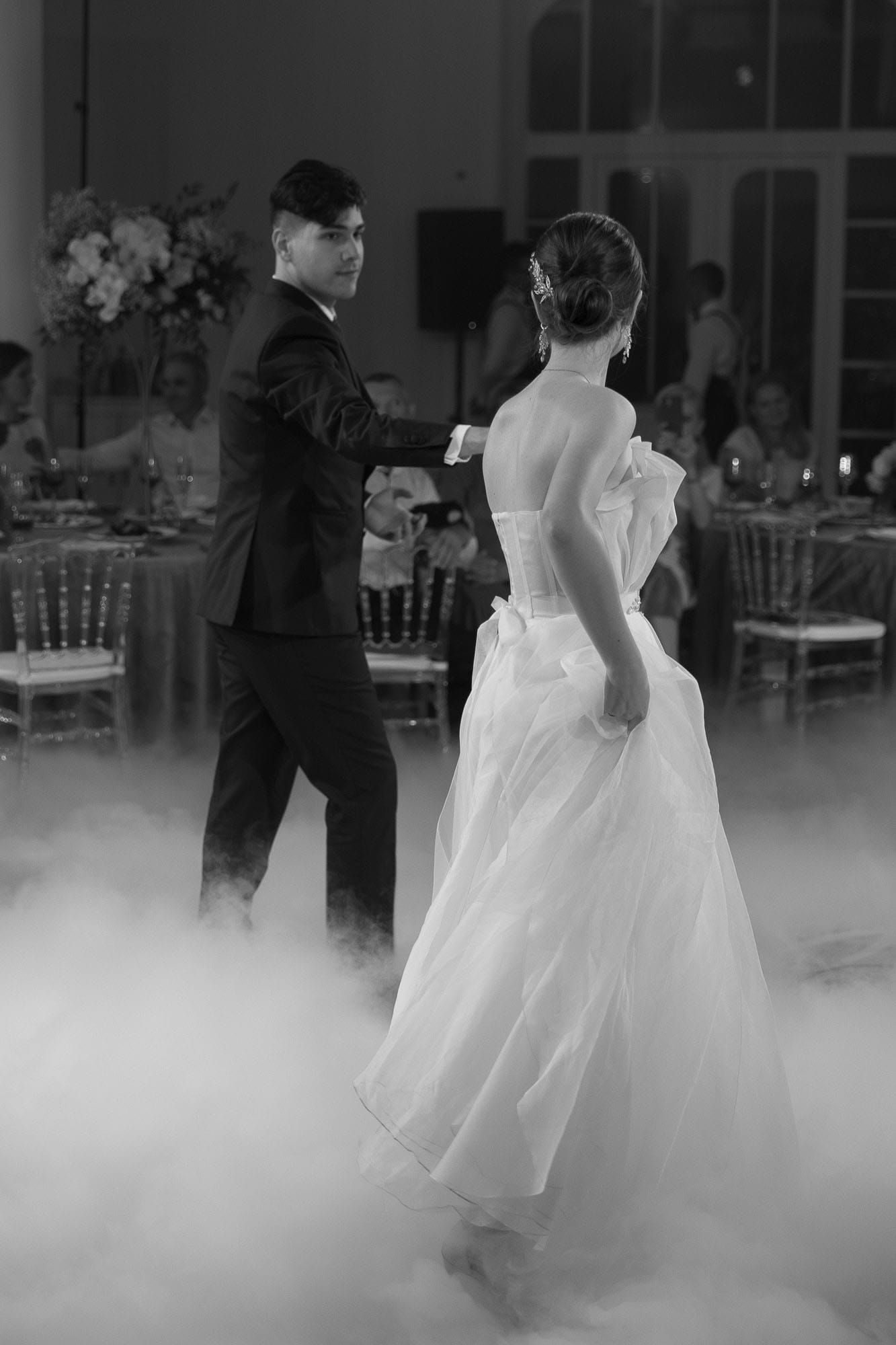 Black and white portrait of the bride and groom during their first dance