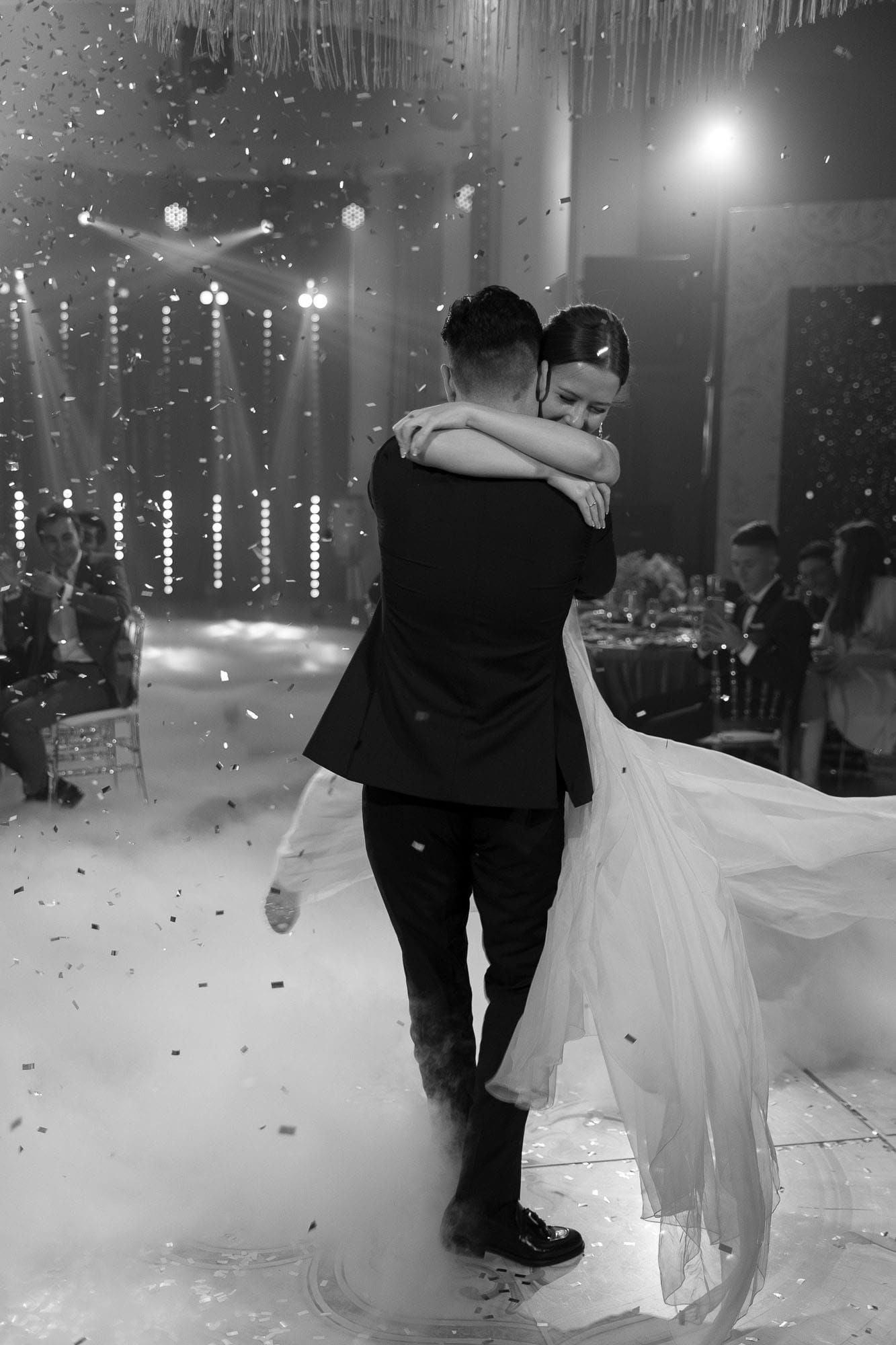 Candid moment of the bride and groom dancing together during their first dance