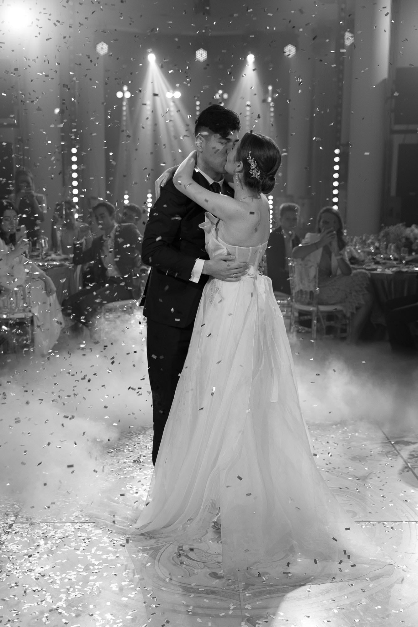 Bride and groom sharing a kiss during their first dance at a destination wedding reception