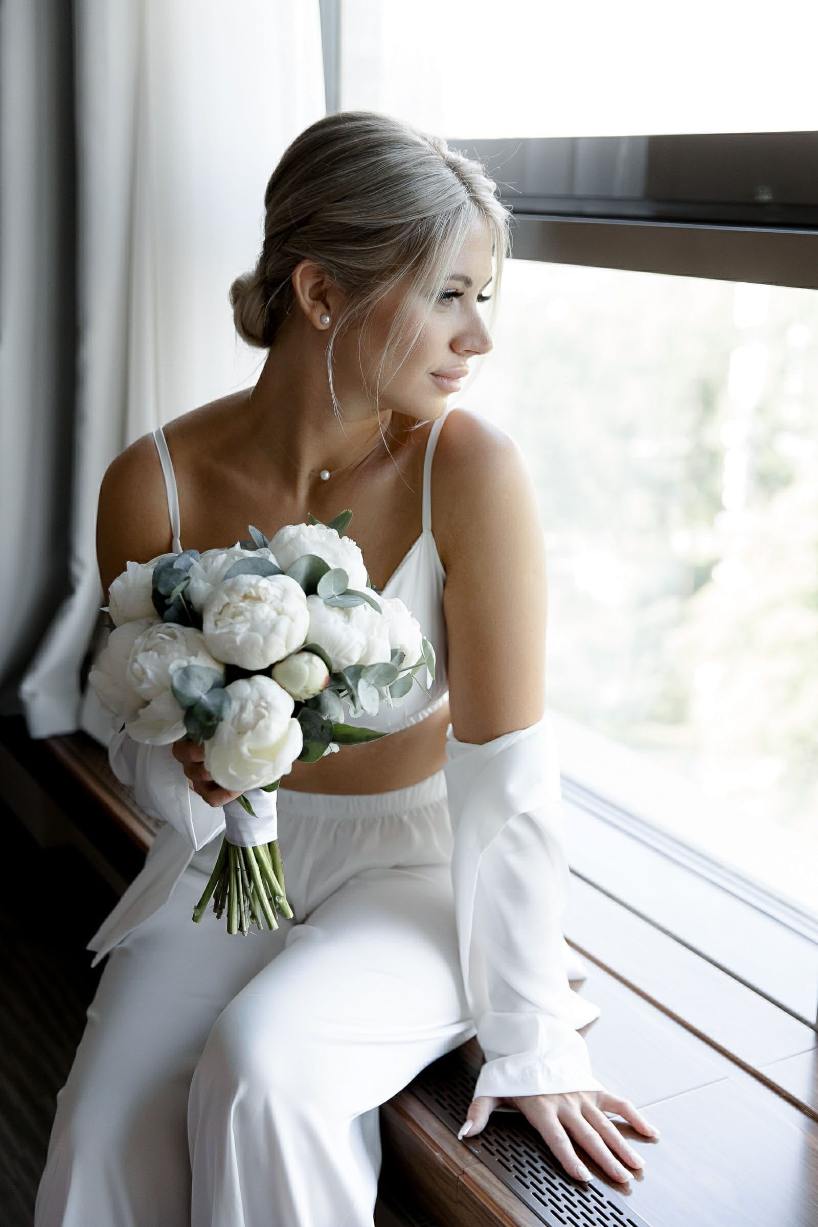 Intimate documentary-style bride in lingerie by a window from Tanya Bogdan Photography.
