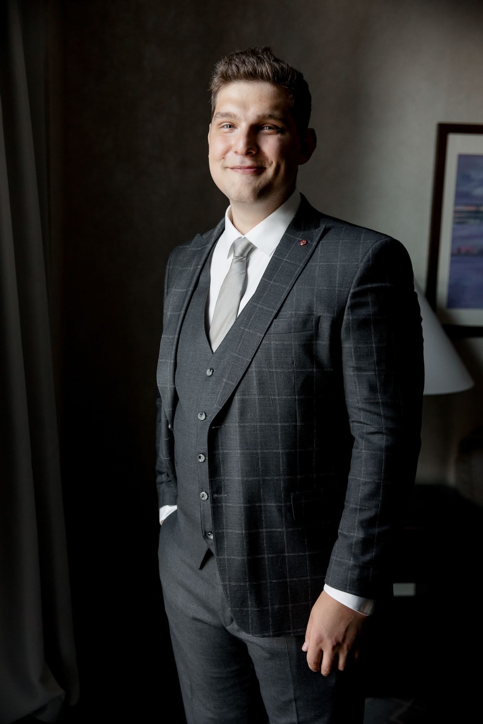 An editorial-style groom portrait with sophisticated lighting by London wedding photographer Tanya Bogdan.