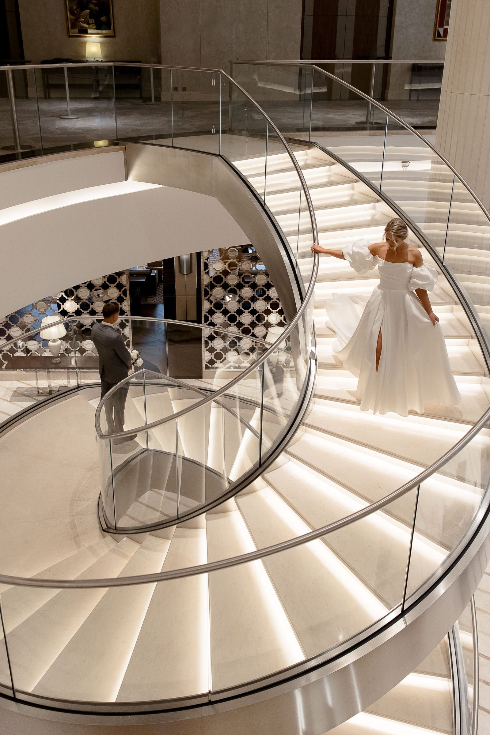 Editorial bridal portrait of the bride descending a spiral staircase from Devon wedding photographer Tanya Bogdan.