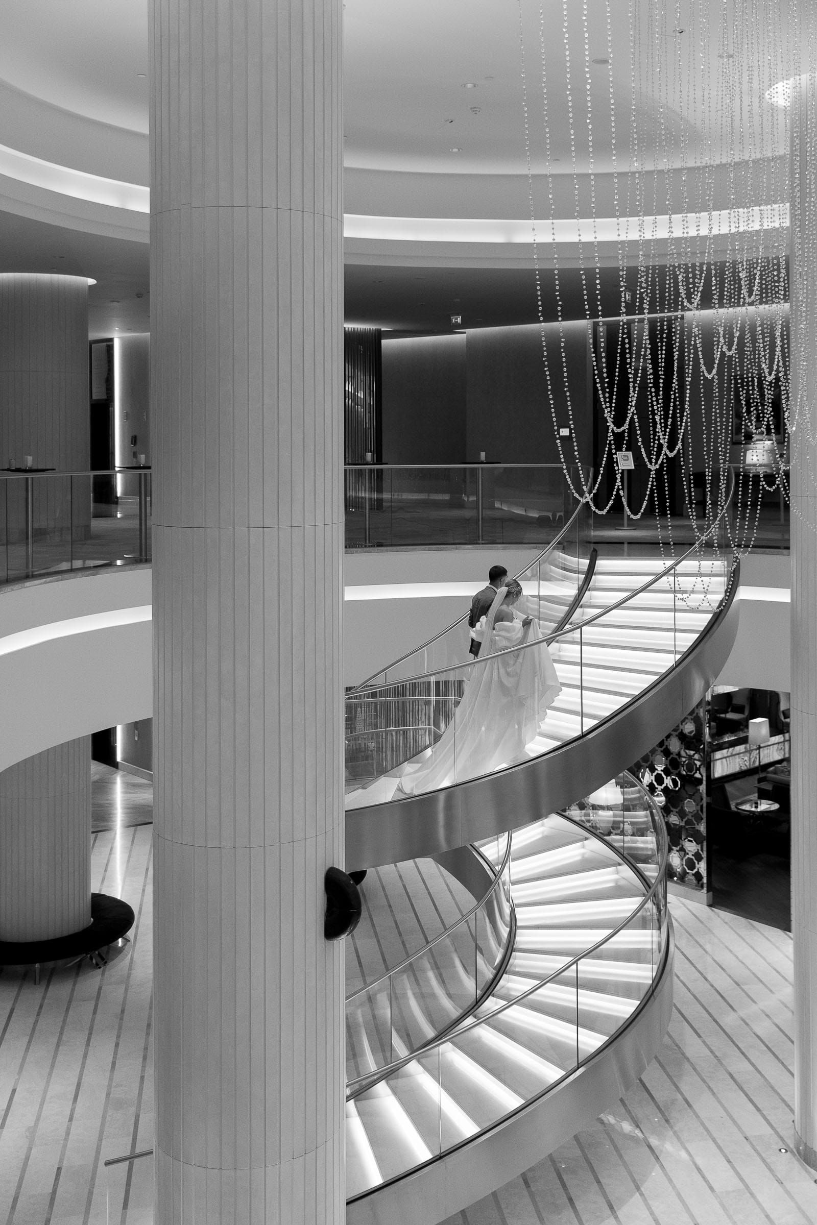 Editorial wedding couple portrait on a grand spiral staircase from London wedding photographer Tanya Bogdan.