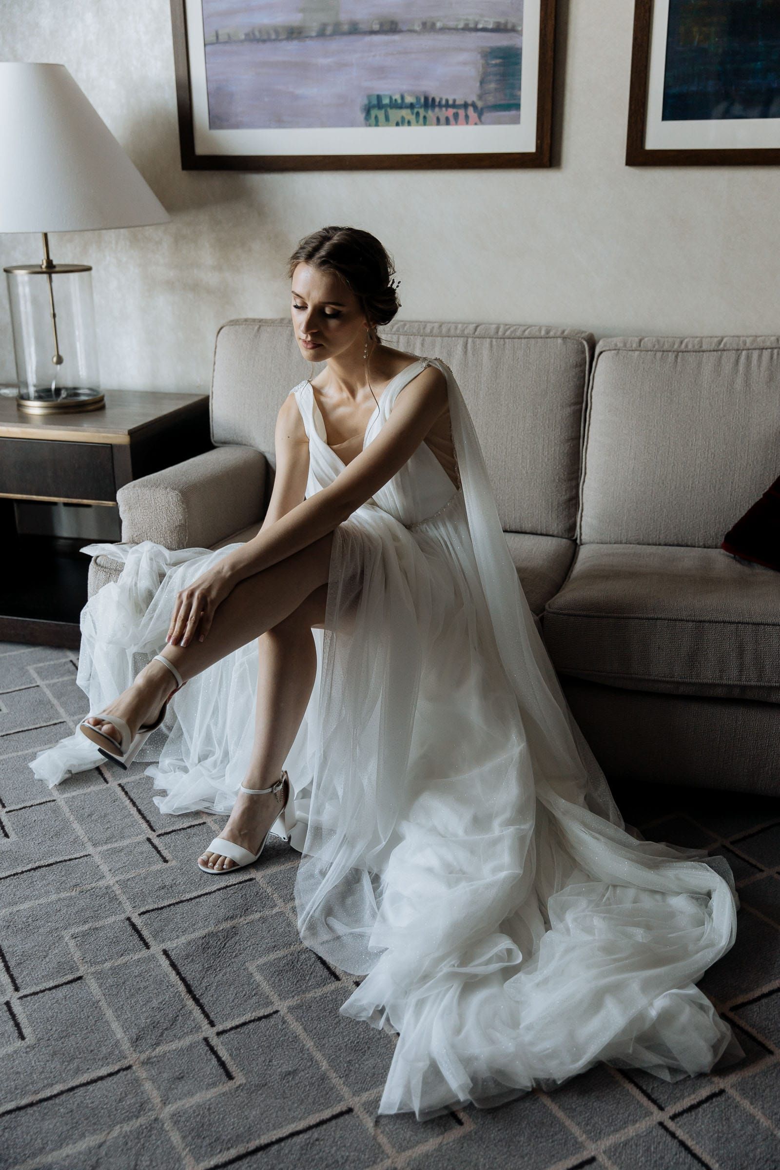 Close-up of a bride putting on her wedding shoes, captured by Cornwall photographer Tanya Bogdan.