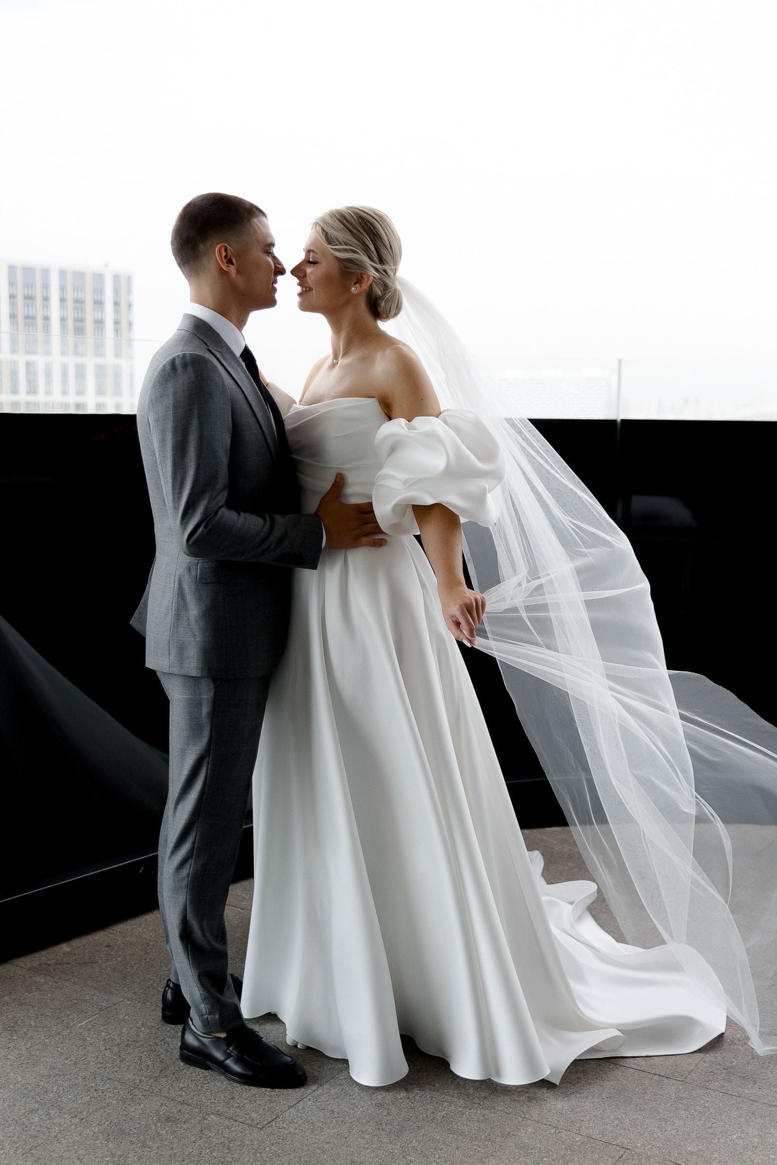 Dramatic editorial bride and groom portrait featuring a flowing dress from Bude wedding photographer Tanya Bogdan.