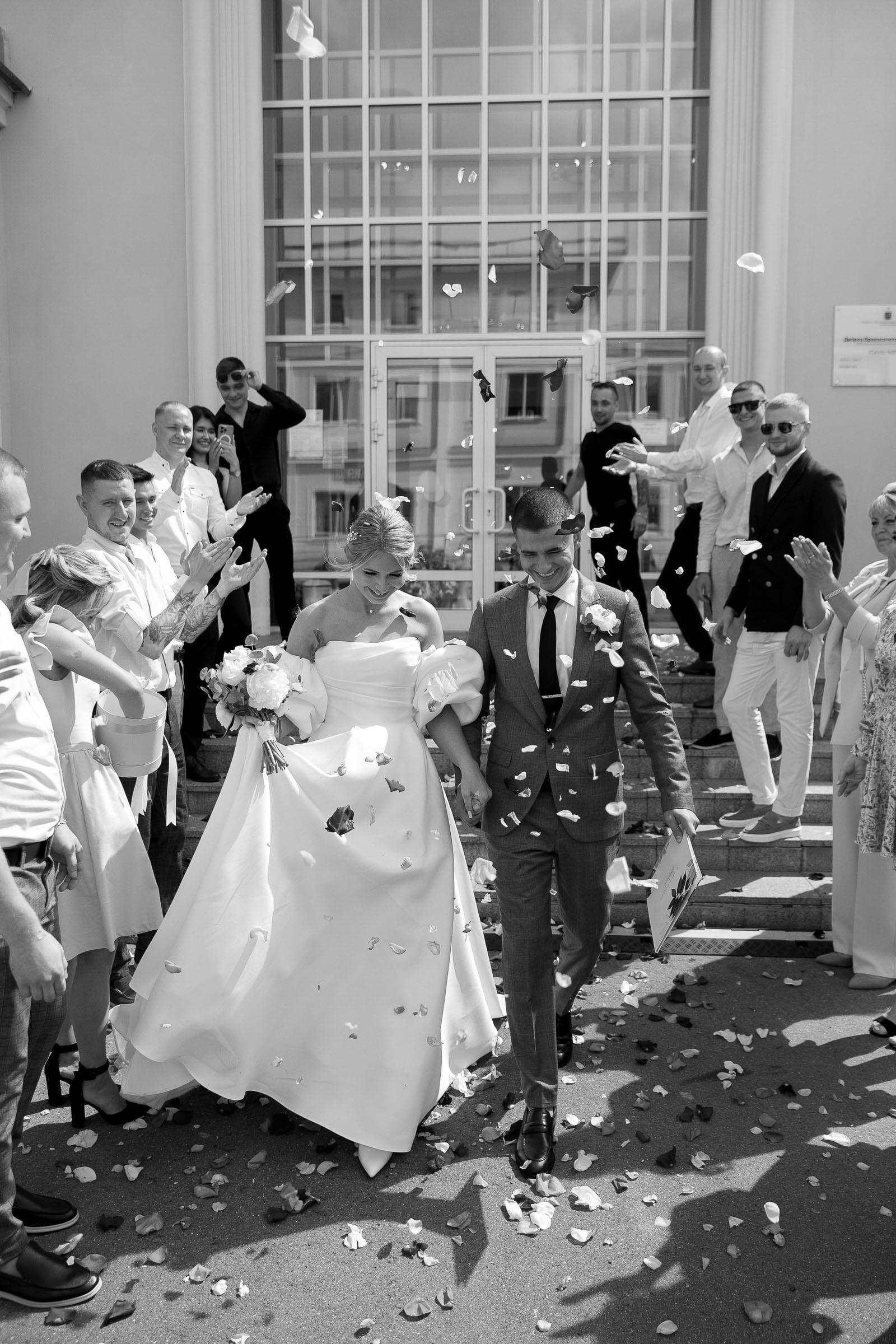 Black and white documentary confetti exit from Bude wedding photographer Tanya Bogdan.