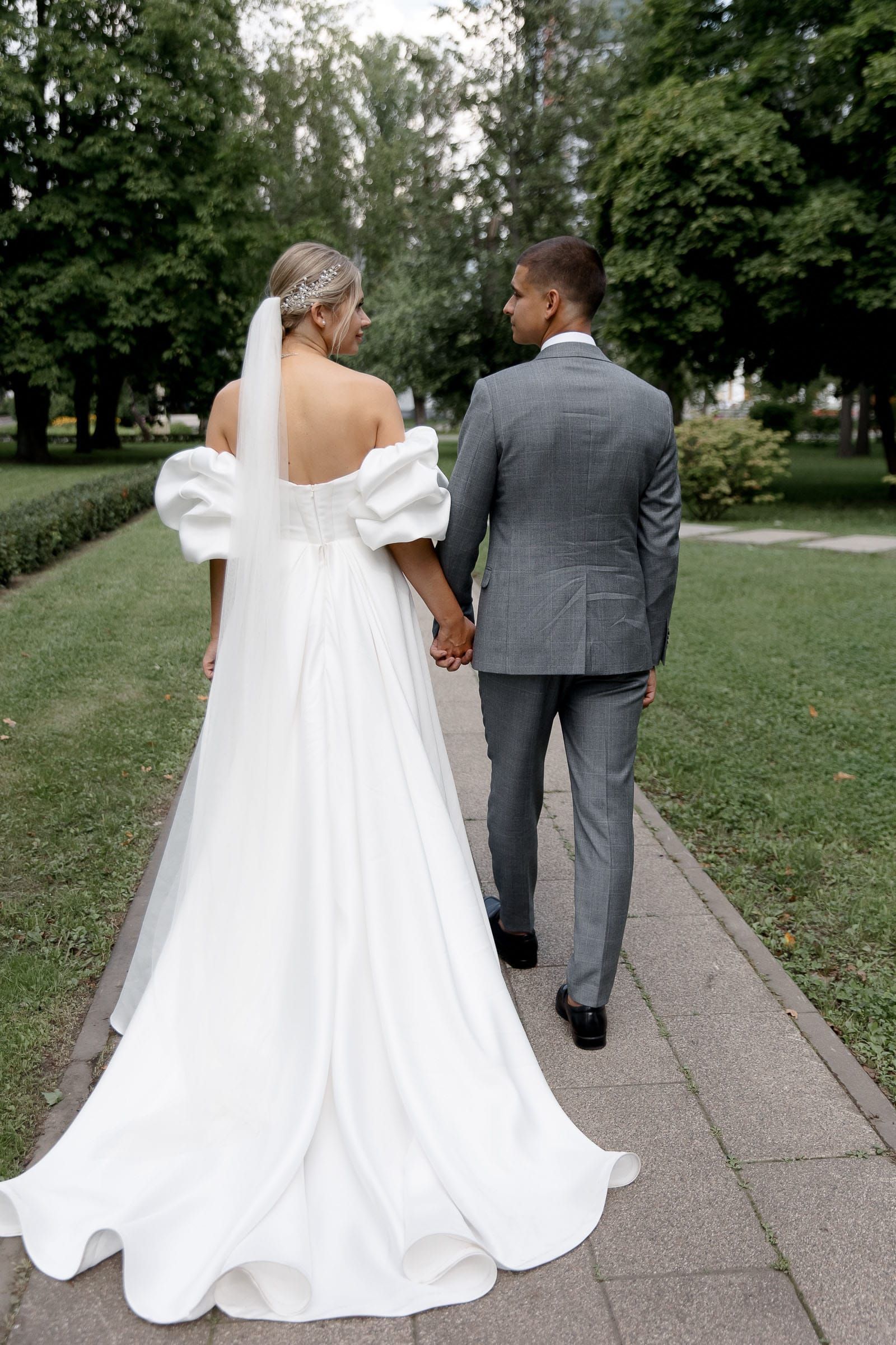 Candid documentary portrait of newlyweds walking from Devon wedding photographer Tanya Bogdan.
