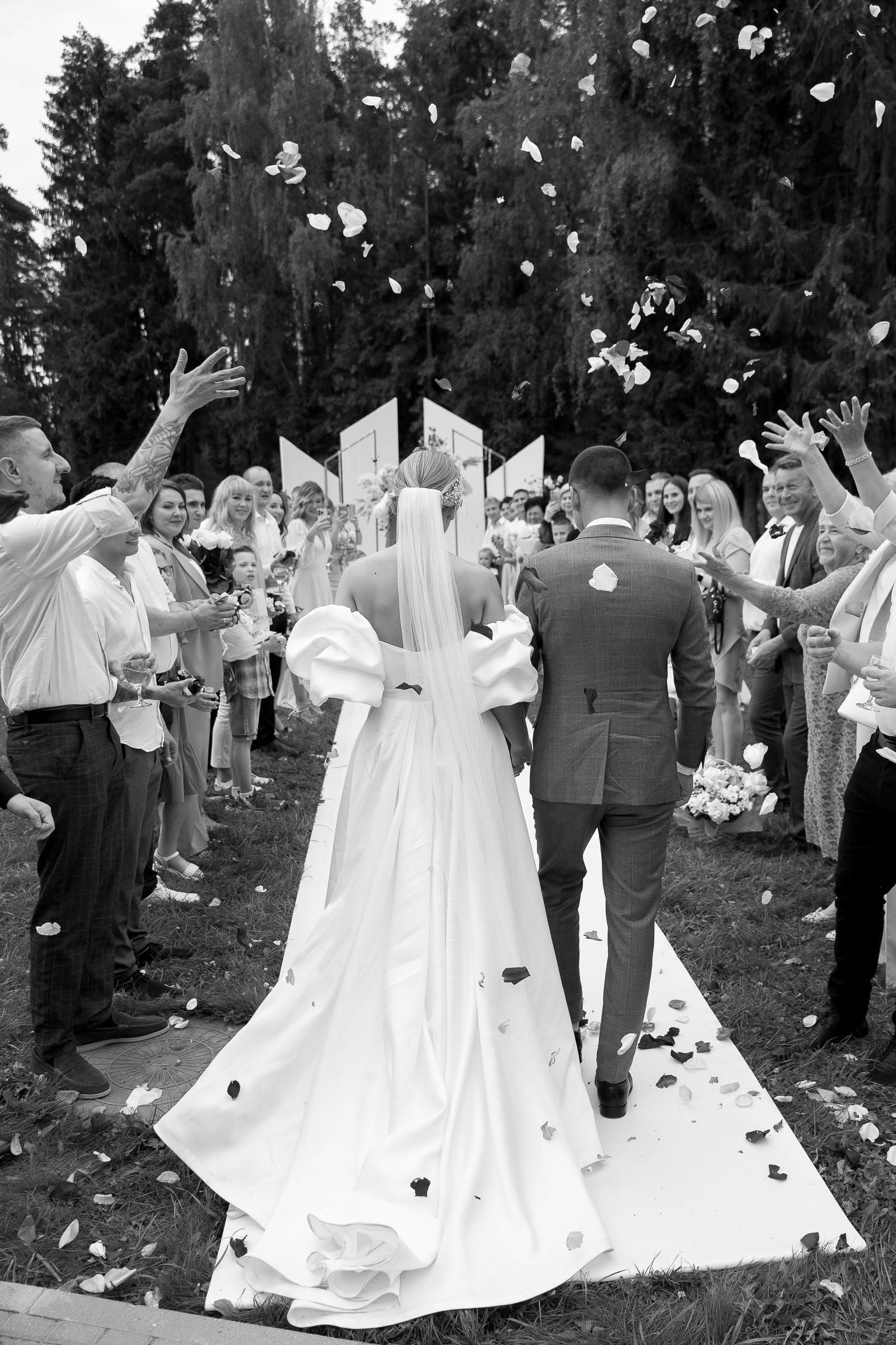 Bride and groom walking down the aisle with confetti at the ceremony photography from Tanya Bogdan.