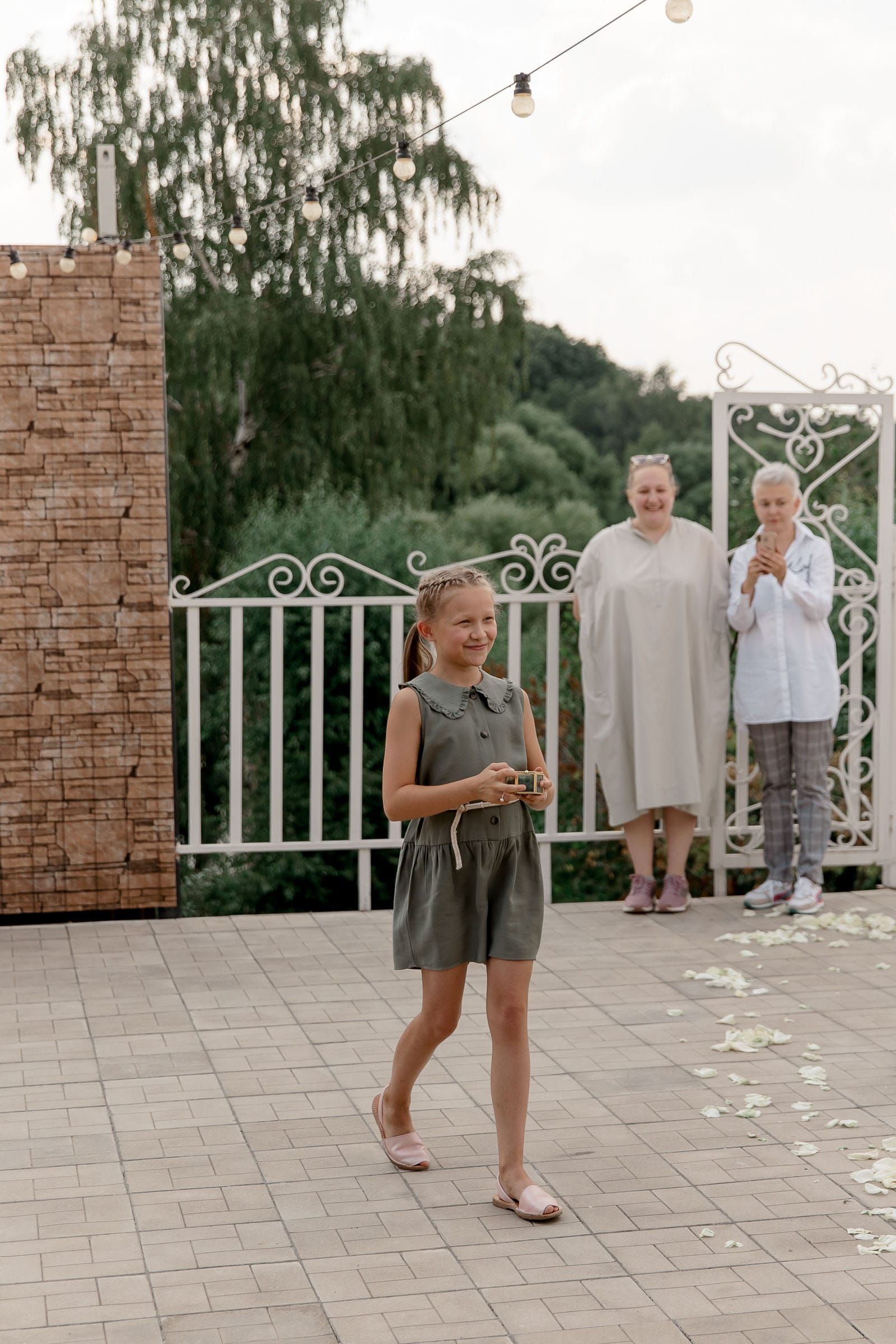 Ring bearer walking to bride and groom, Wide shot of a wedding ceremony in progress by Tanya Bogdan Photography.