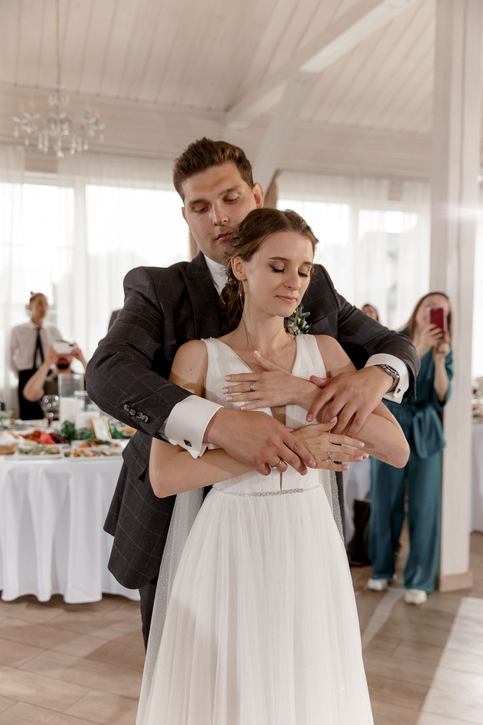 Emotional first dance lighting at a wedding reception, photographed by a Cornwall wedding photographer.