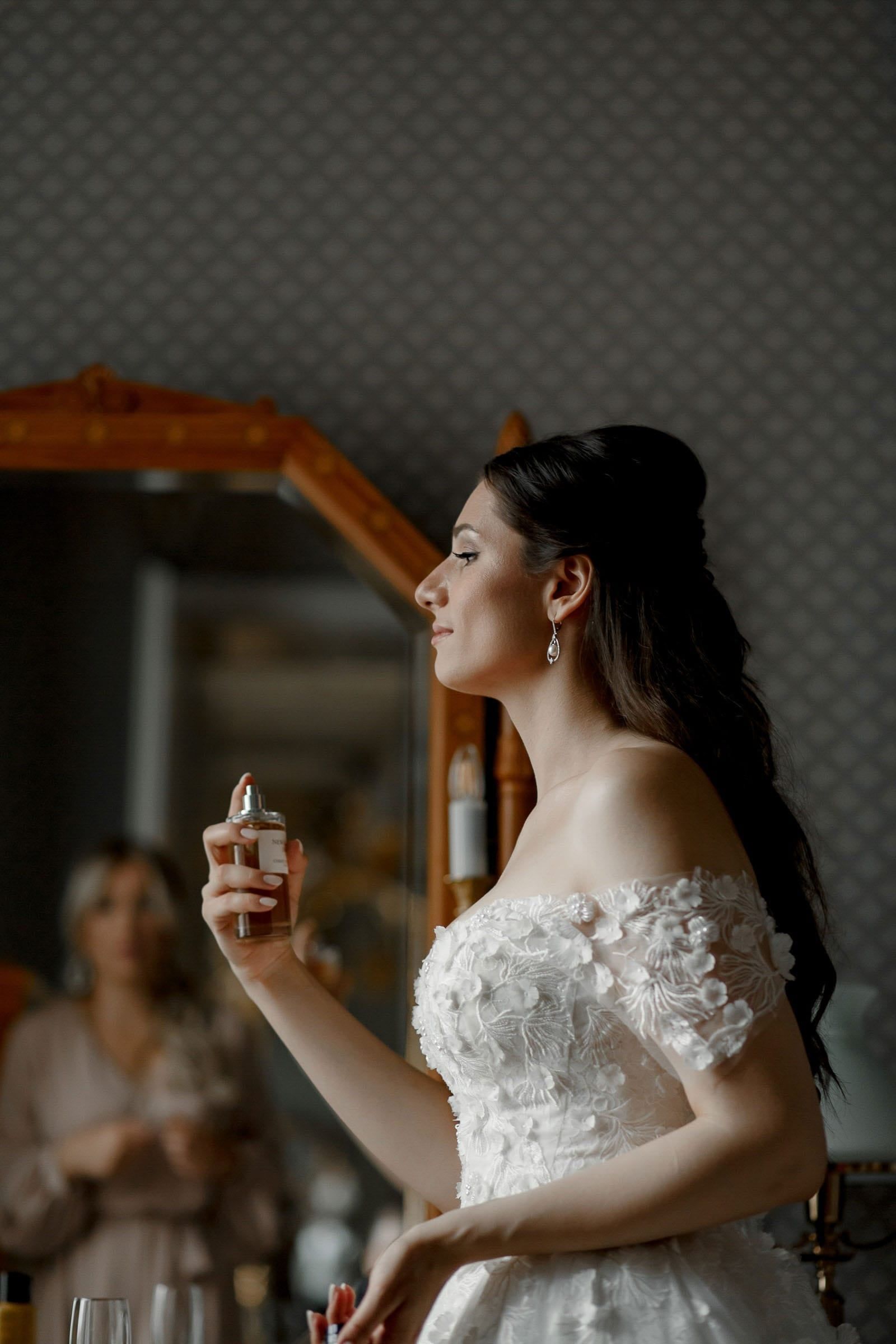 An editorial shot of a bride with her wedding perfume by Tanya Bogdan.