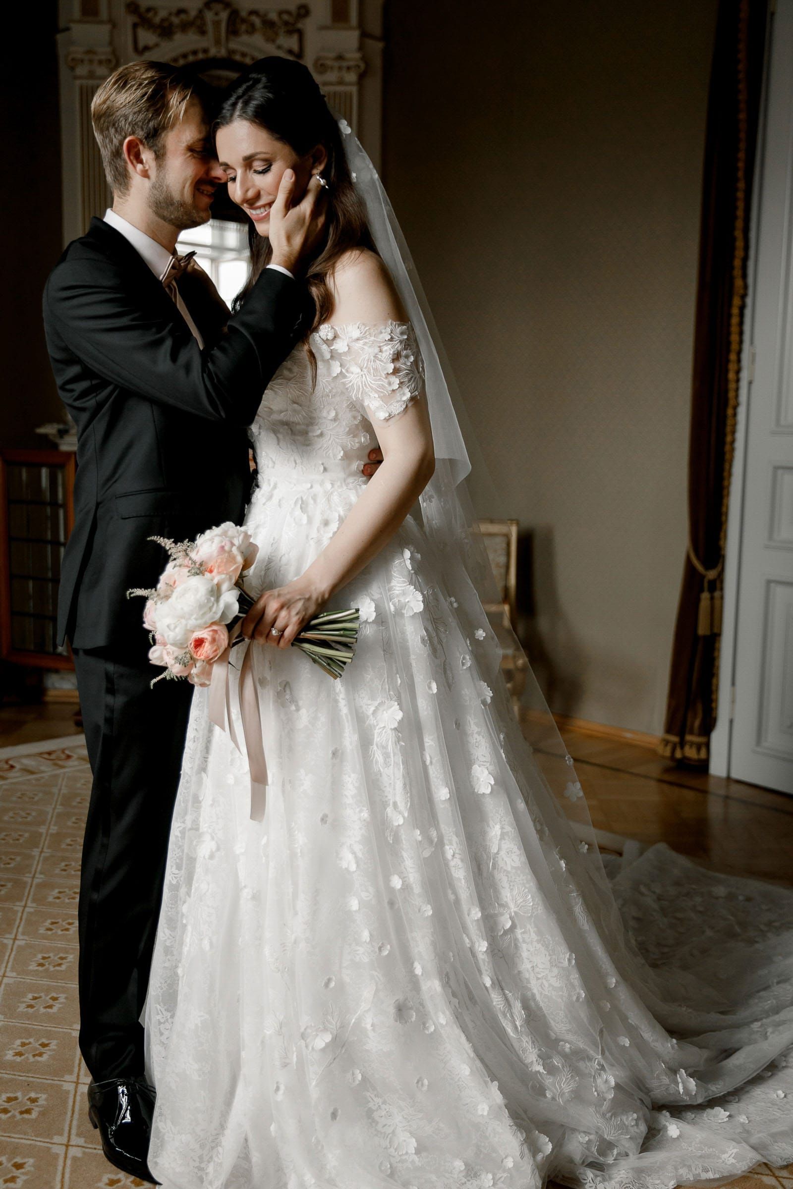An editorial portrait of a bride and groom in a grand room by Tanya Bogdan, serving Devon and London.