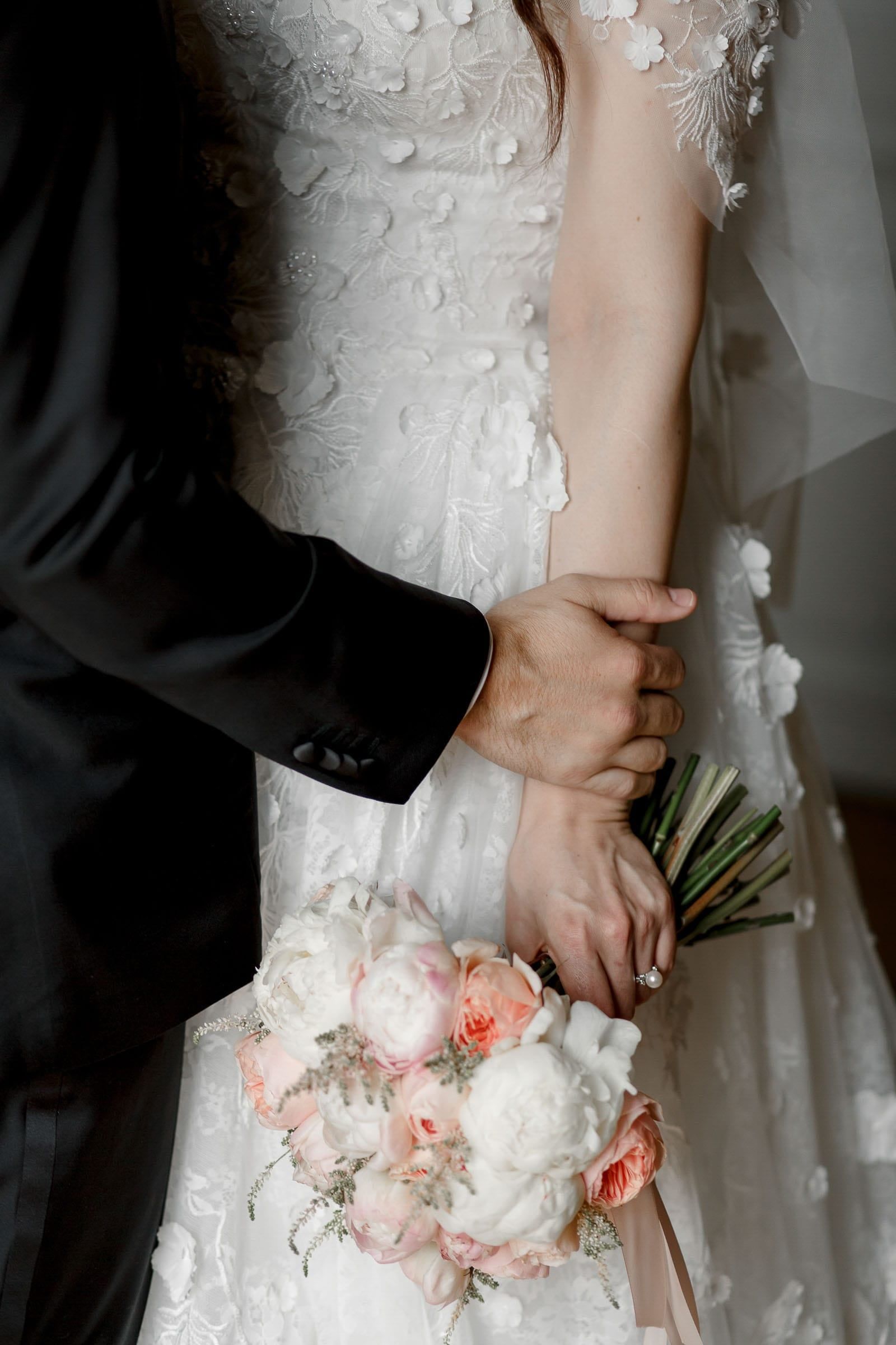 A close-up editorial shot of a luxury bridal bouquet.