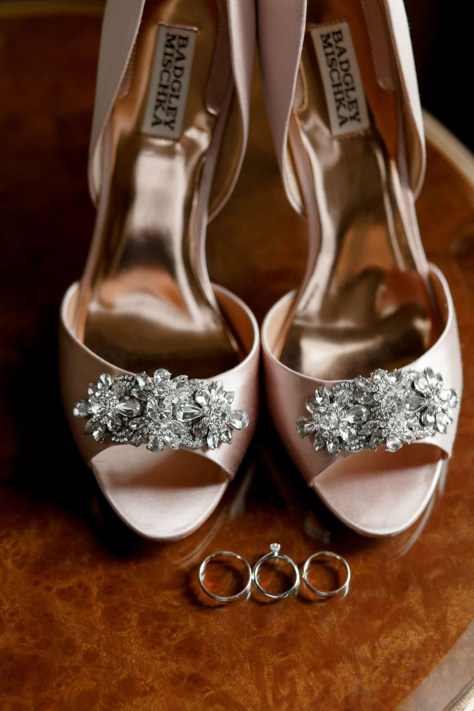 Editorial shot of luxury wedding shoes and rings by high-end wedding photographer Tanya Bogdan.