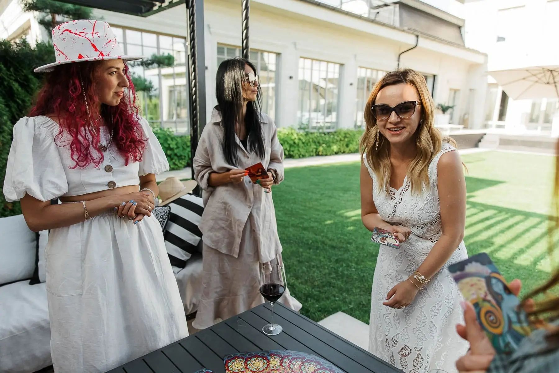 Candid shots of guests socialising and mingling during a garden celebration, by Bude photographer Tanya Bogdan.