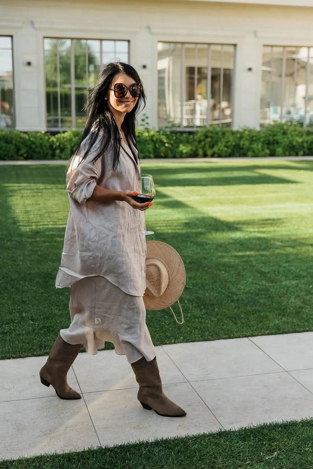 An individual portrait of a guest showcasing chic summer fashion at a garden event, by Bude photographer Tanya Bogdan.