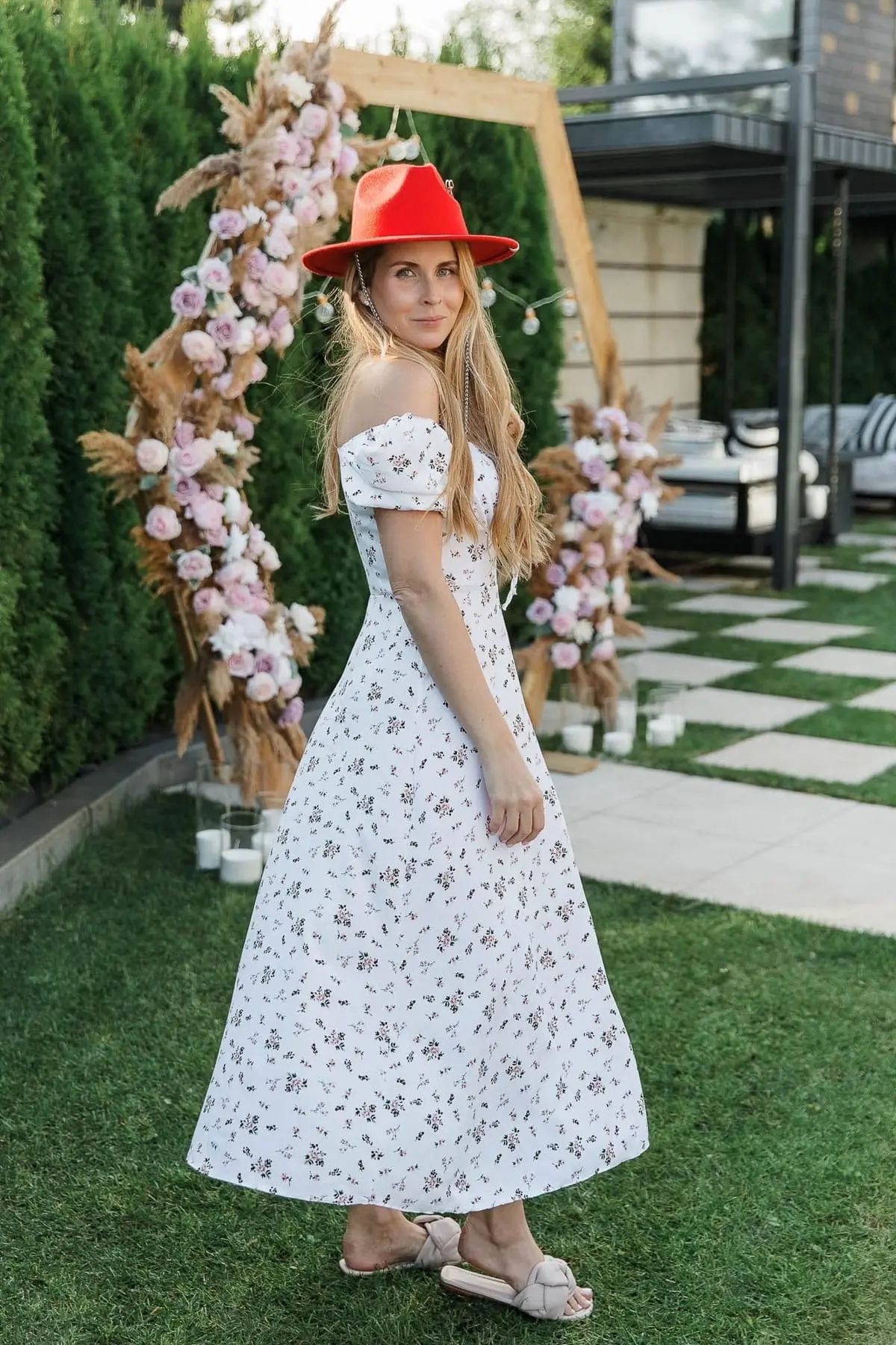 A graceful portrait of a woman in a floral garden setting at a luxury event, by Salcombe photographer Tanya Bogdan.