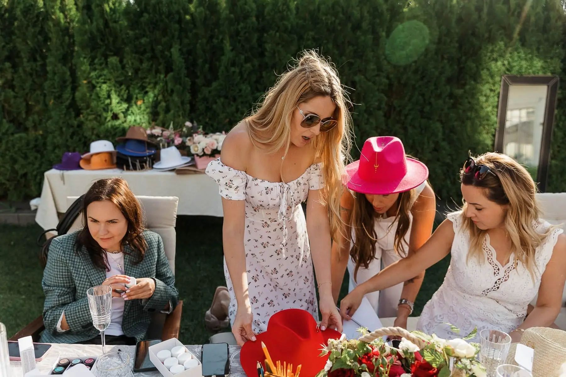 A candid shot of a guest participating in a creative hat-painting workshop, by Exeter photographer Tanya Bogdan.