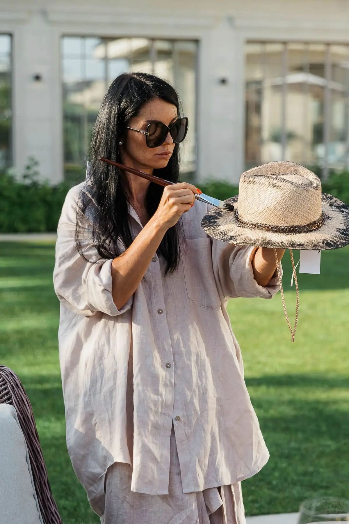 A close-up detail shot of the hat-painting process at a creative luxury event, by Totnes photographer Tanya Bogdan.