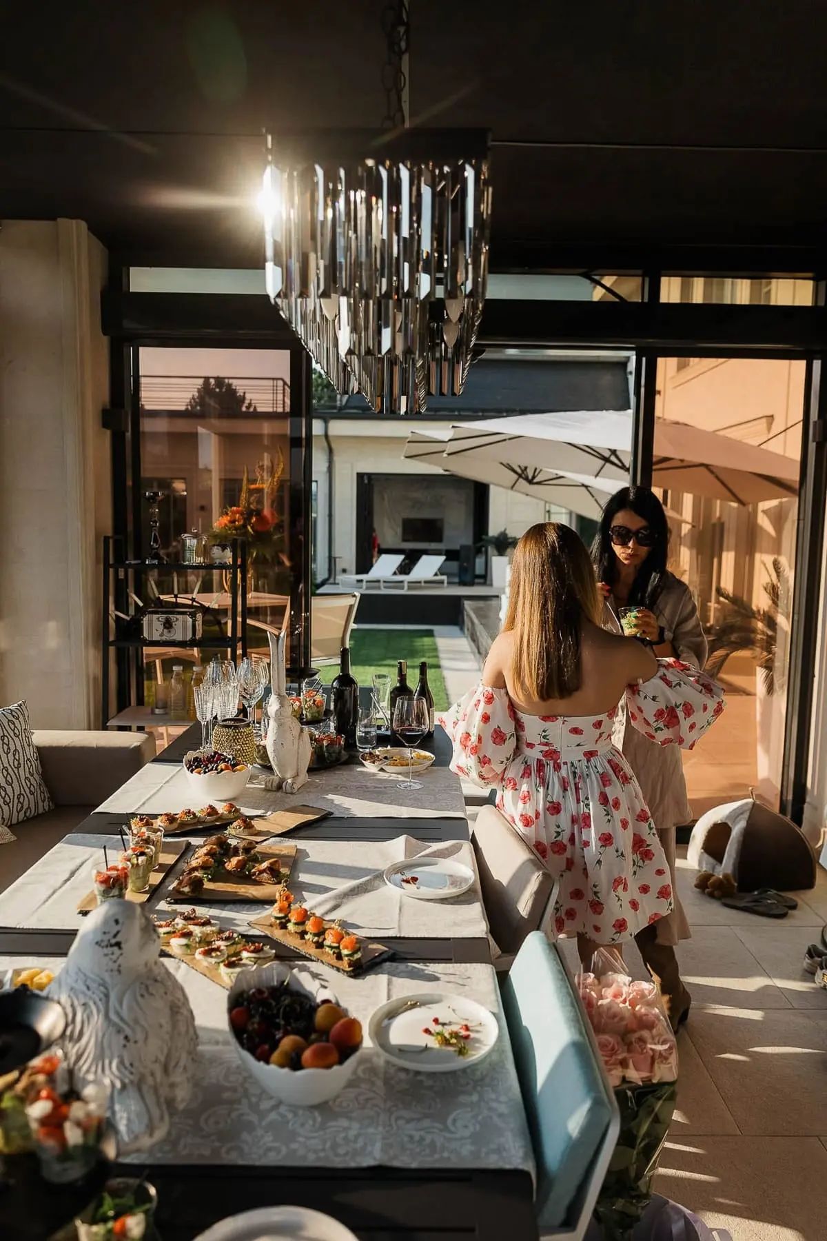 A storytelling lifestyle shot of guests interacting at a high-end garden party, by Falmouth photographer Tanya Bogdan.
