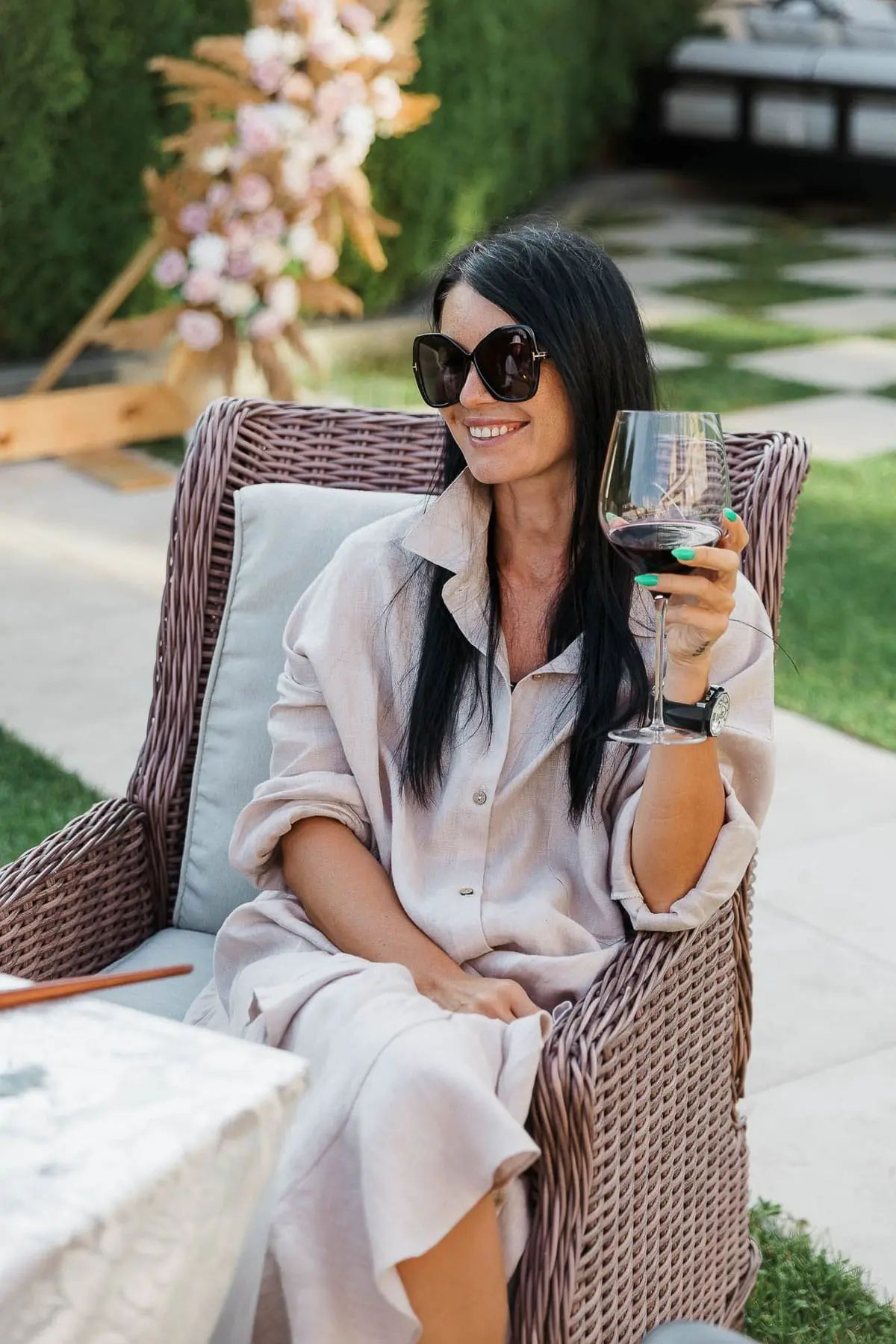 Candid shot of guests enjoying drinks and conversation at a luxury garden soiree, by Salcombe photographer Tanya Bogdan.