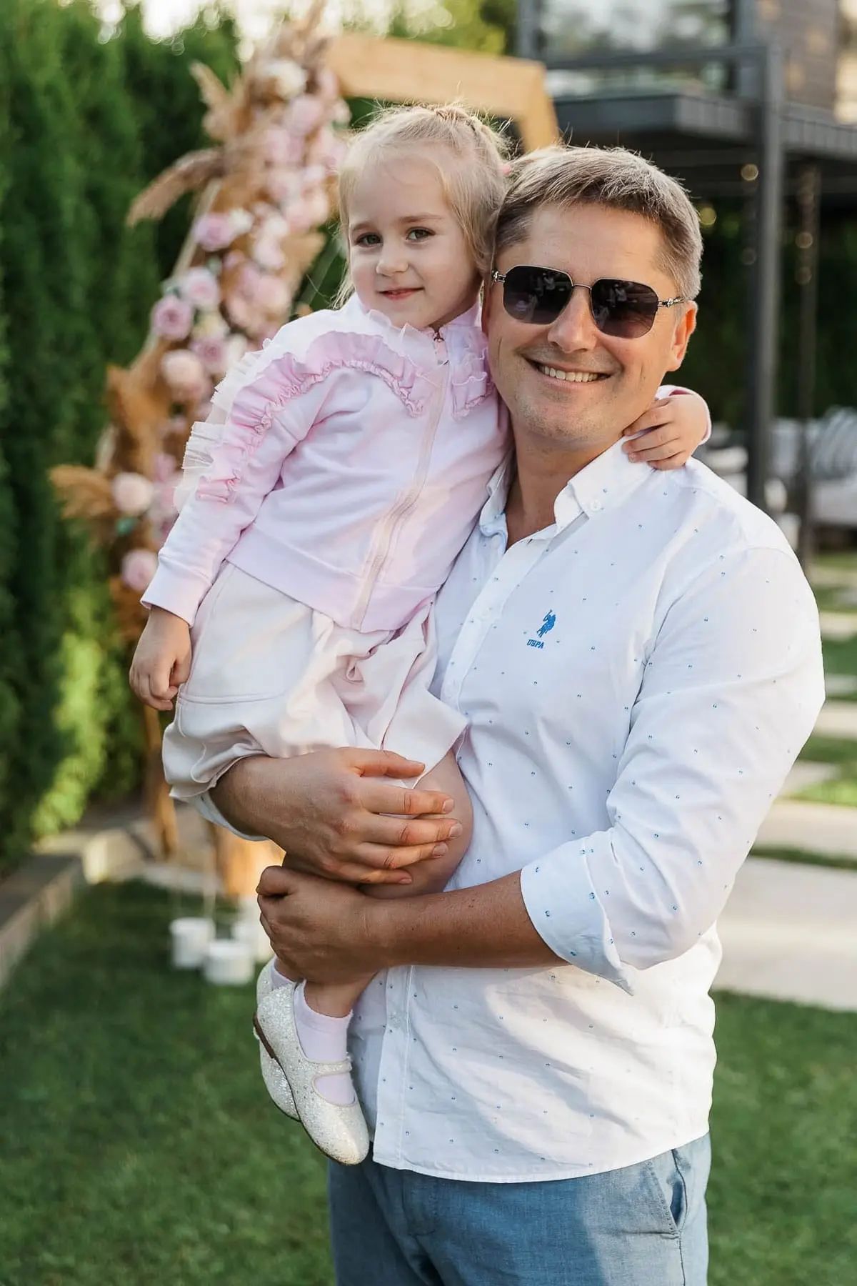 A heartwarming portrait of a father and daughter posing together at a luxury birthday party, by Bude photographer Tanya Bogdan.