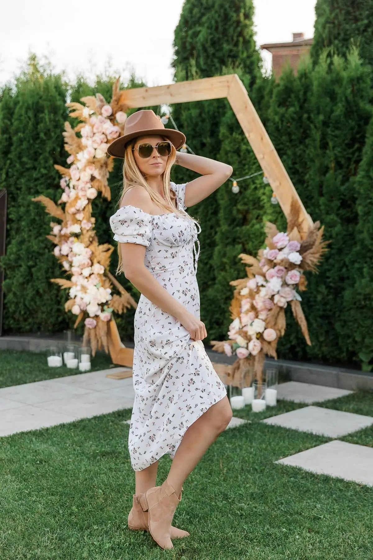 An individual guest posing gracefully against a custom floral arrangement, by Bude photographer Tanya Bogdan.