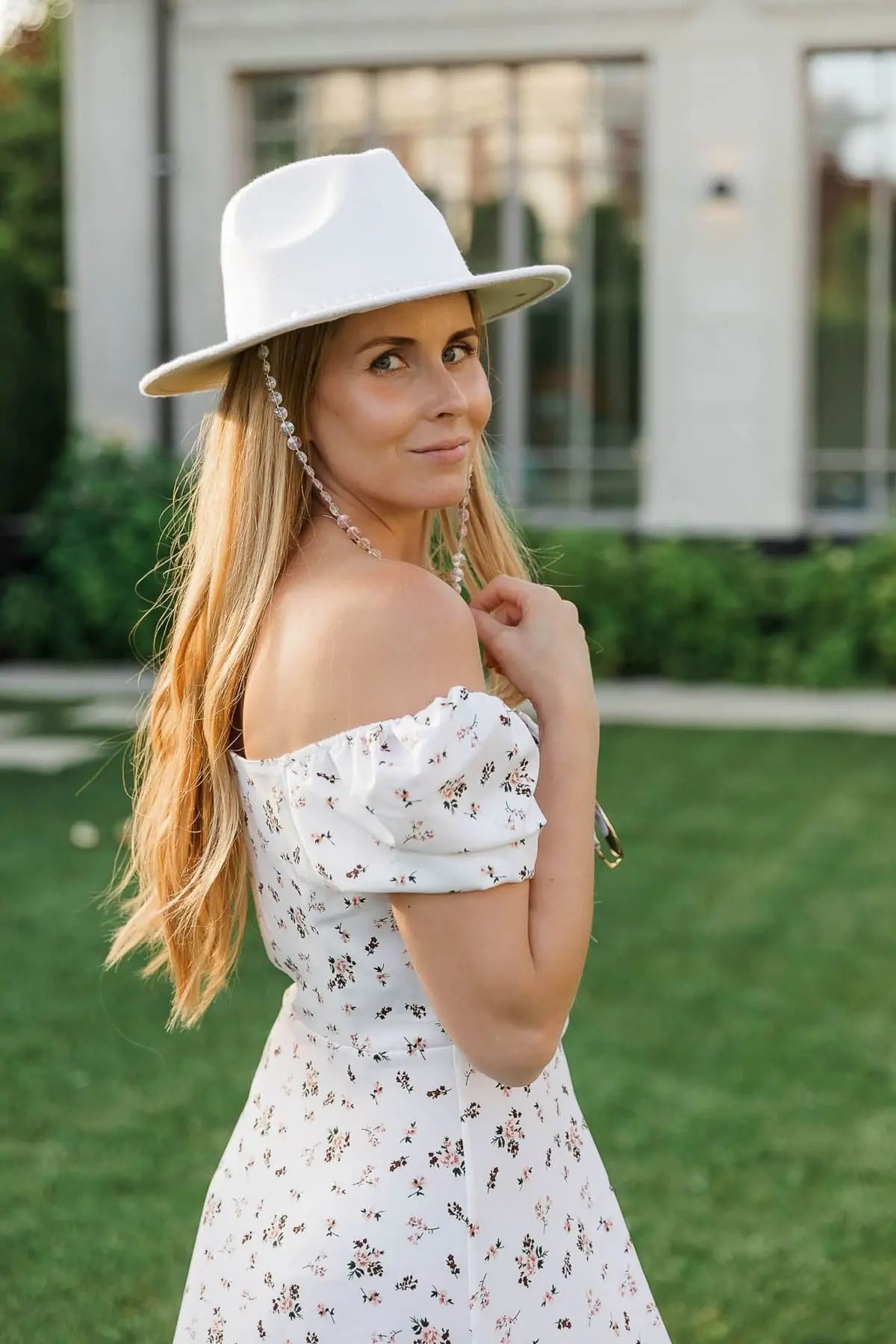 An individual portrait capturing the warm summer glow of a guest at a luxury outdoor event, by Bude photographer Tanya Bogdan.