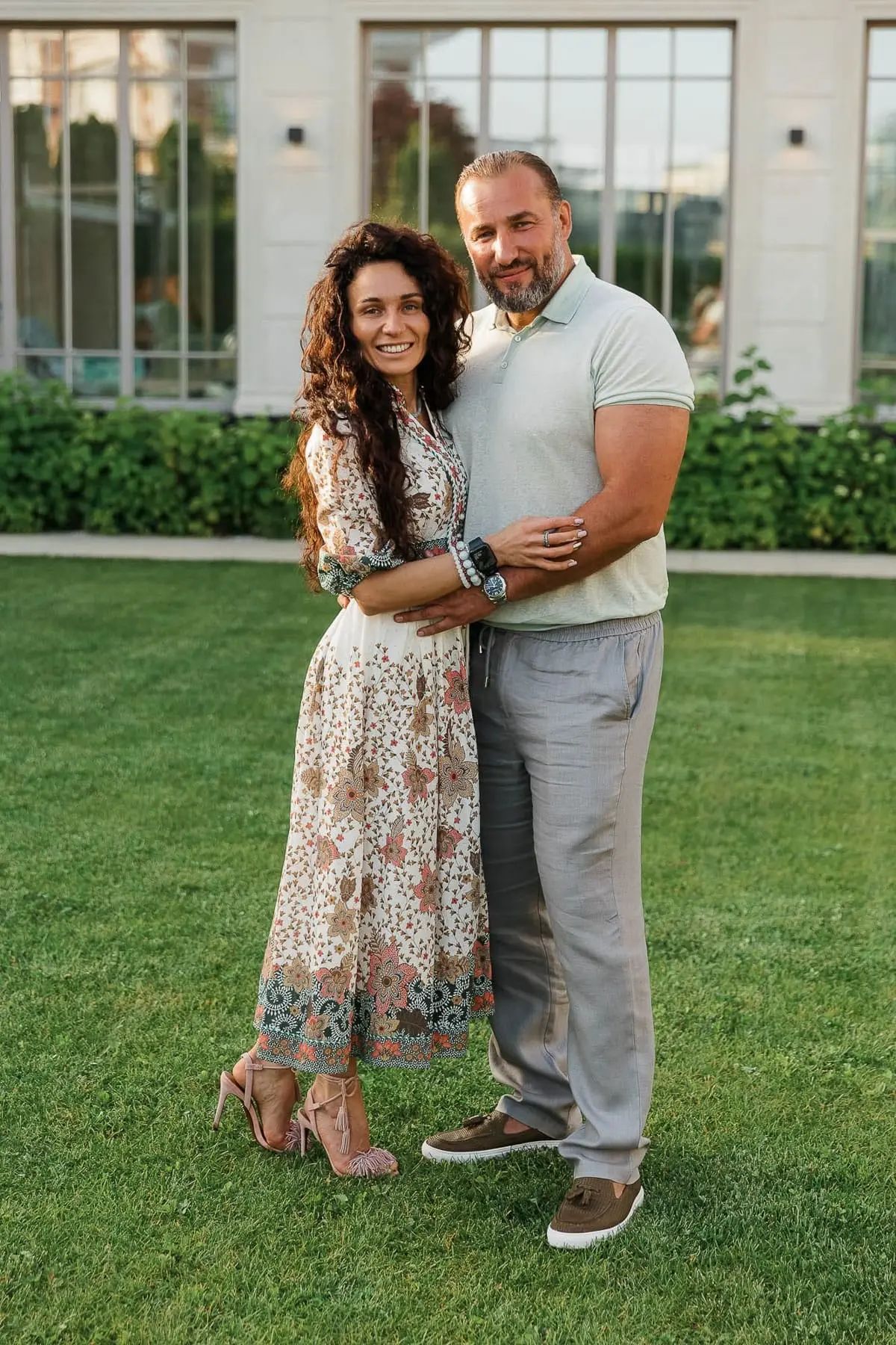 A stylish couple posing in a beautifully landscaped garden during a private celebration, by Bude photographer Tanya Bogdan.