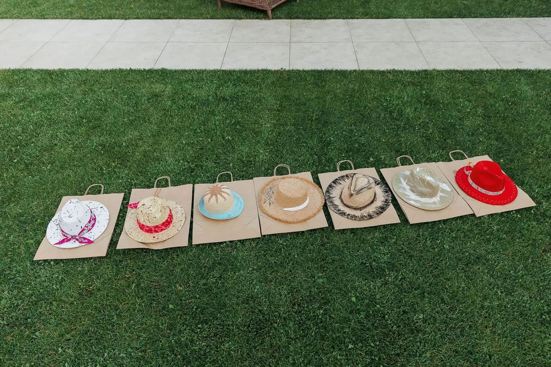 A lifestyle shot featuring a creative hat-painting station at a high-end garden party, by Cornwall photographer Tanya Bogdan.