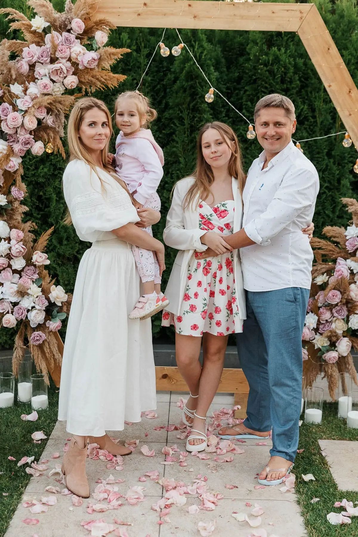 A full-length portrait of a family dressed in summer attire at a luxury garden party, by Falmouth photographer Tanya Bogdan.