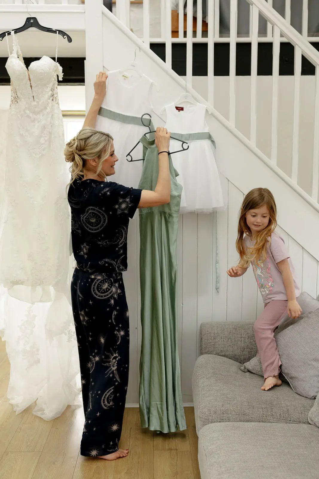 Bridesmaids get ready with the flower girl before the wedding at Glebe Barn in Devon.