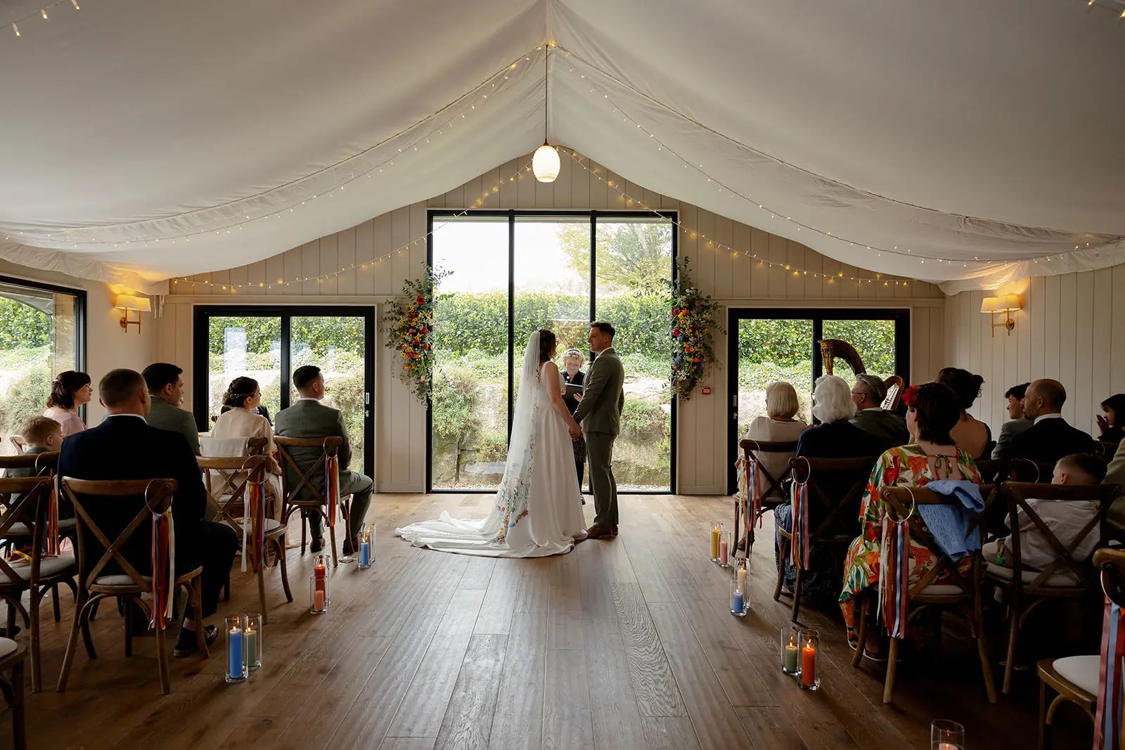 Bride and Groom holding hands at a Trevenna wedding ceremony in Cornwall. By Tanya Bogdan Photography.