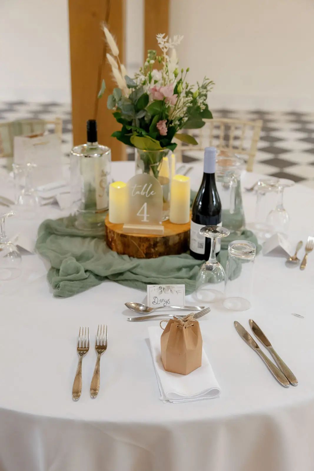 A wedding table setting and floral centrepiece at Glebe Barn in Devon.