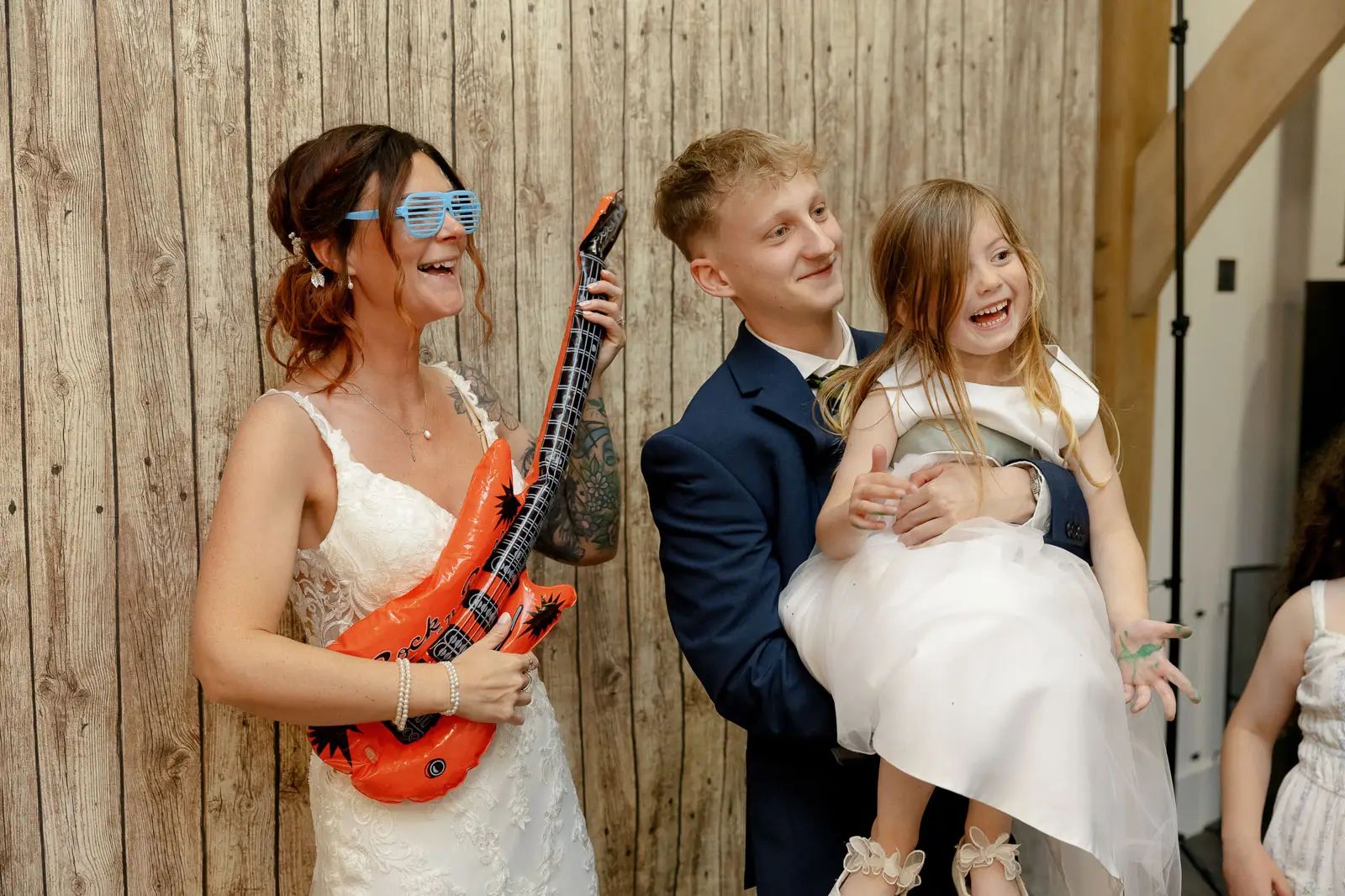 A bride and children playing at wedding at Glebe Barn in Devon.