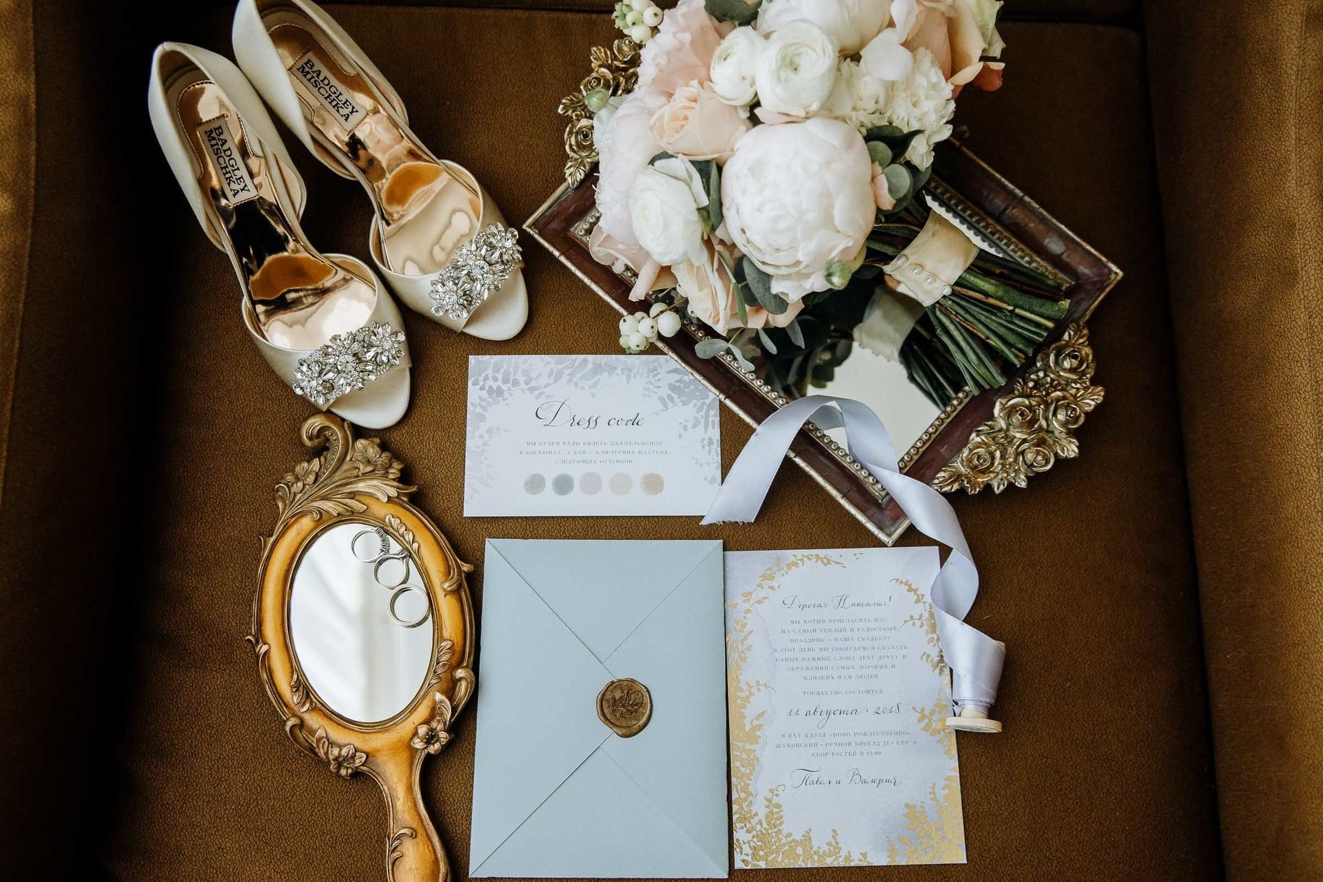 A minimalist wedding detail flatlay featuring stationery and accessories, captured by Devon wedding photographer Tanya Bogdan.