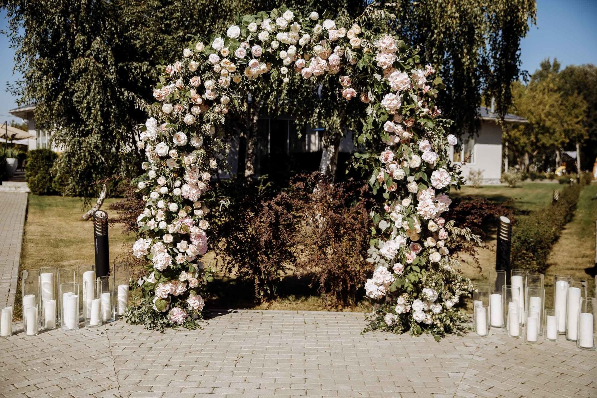 Beautiful outdoor floral arch decor for a wedding ceremony, by a wedding photographer, Tanya Bogdan.