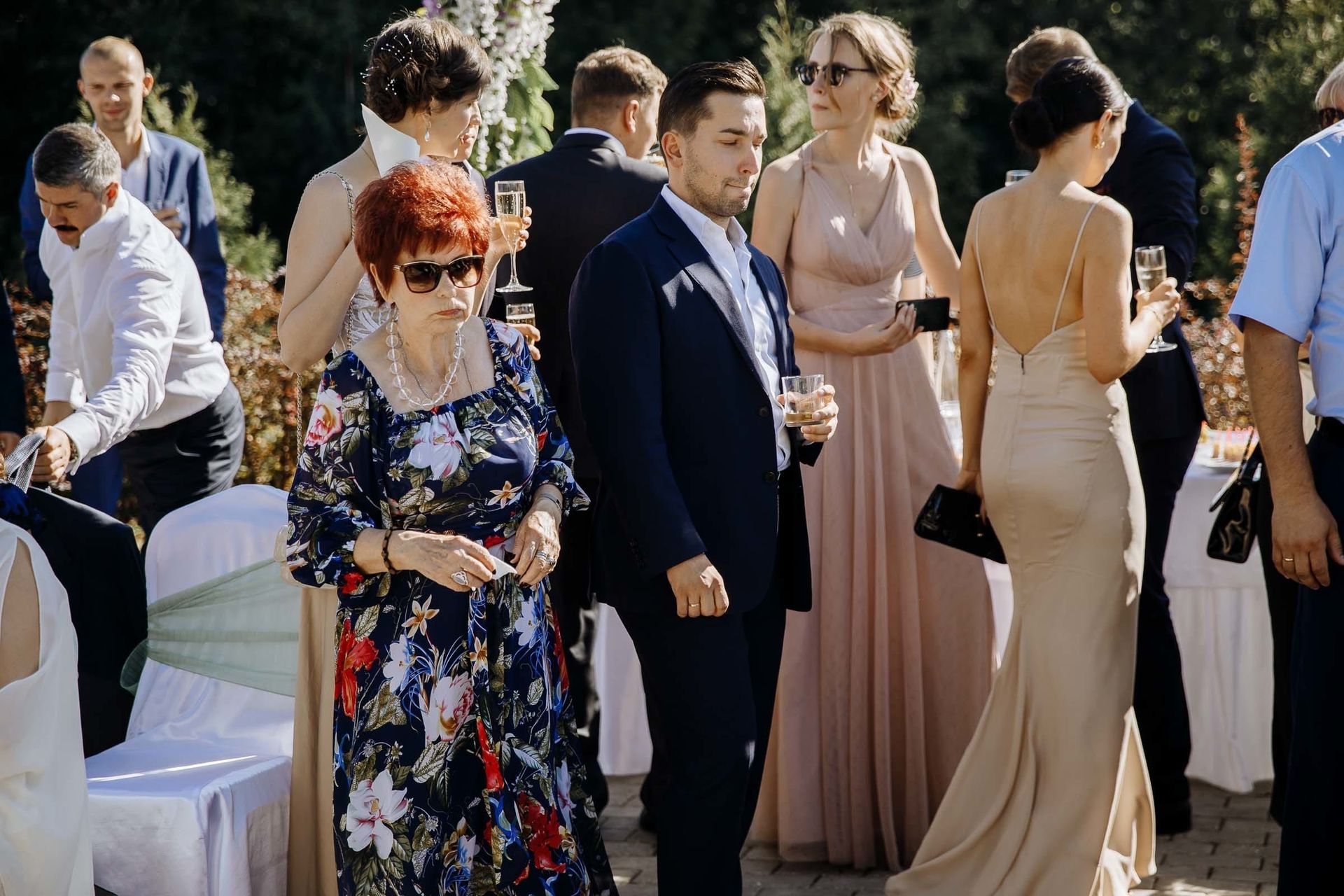 Candid documentary photography of guests at an outdoor wedding.