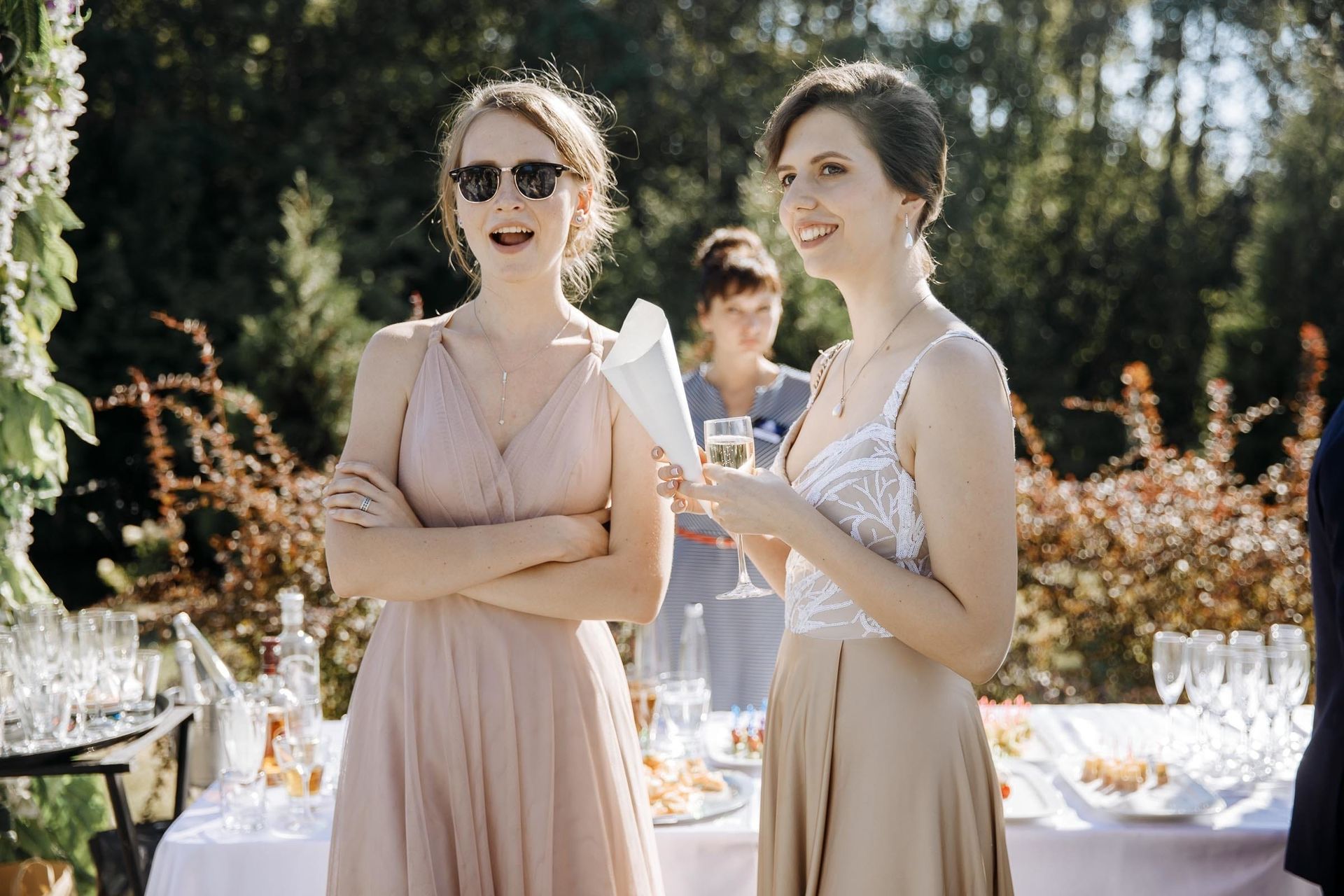 Documentary shot of wedding guests interacting during an outdoor celebration.