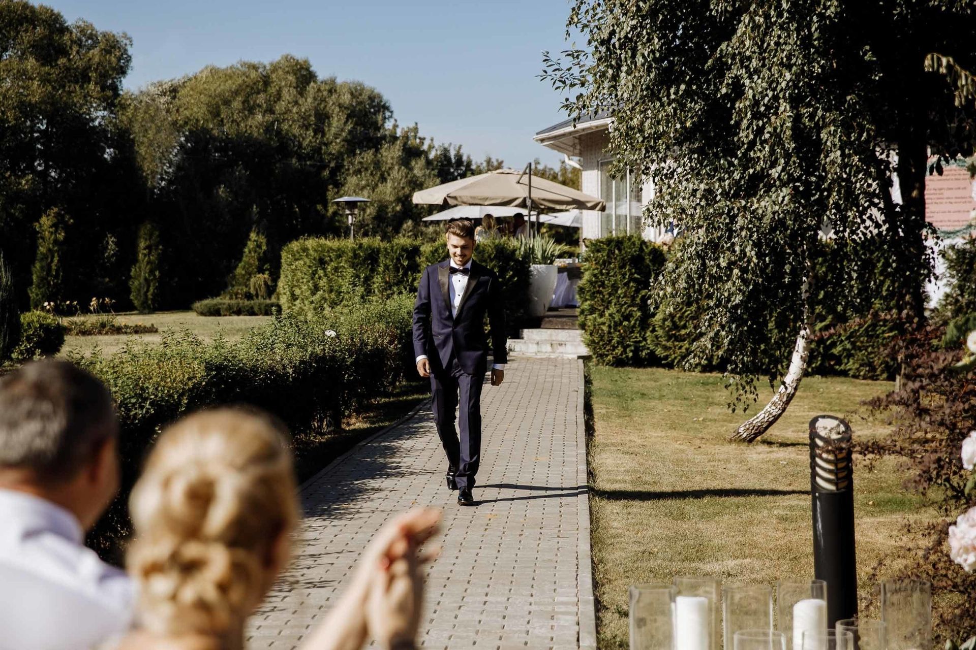 Groom walking down the aisle at an outdoor ceremony, by a Cornwall wedding photographer, Tanya Bogdan.